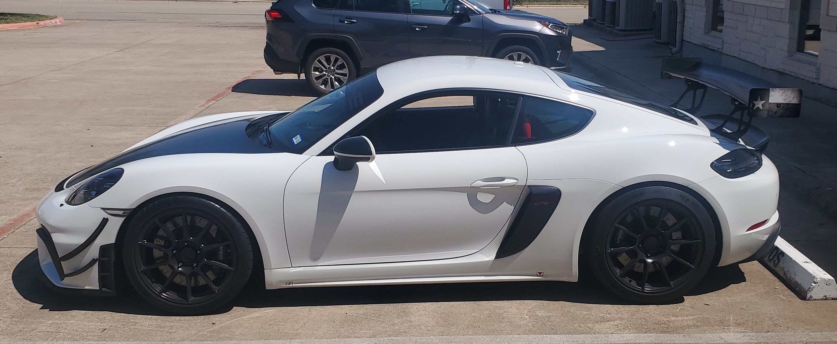 White Porsche 718 Cayman GT4 with 19" SM-10 Apex wheels in Satin Black