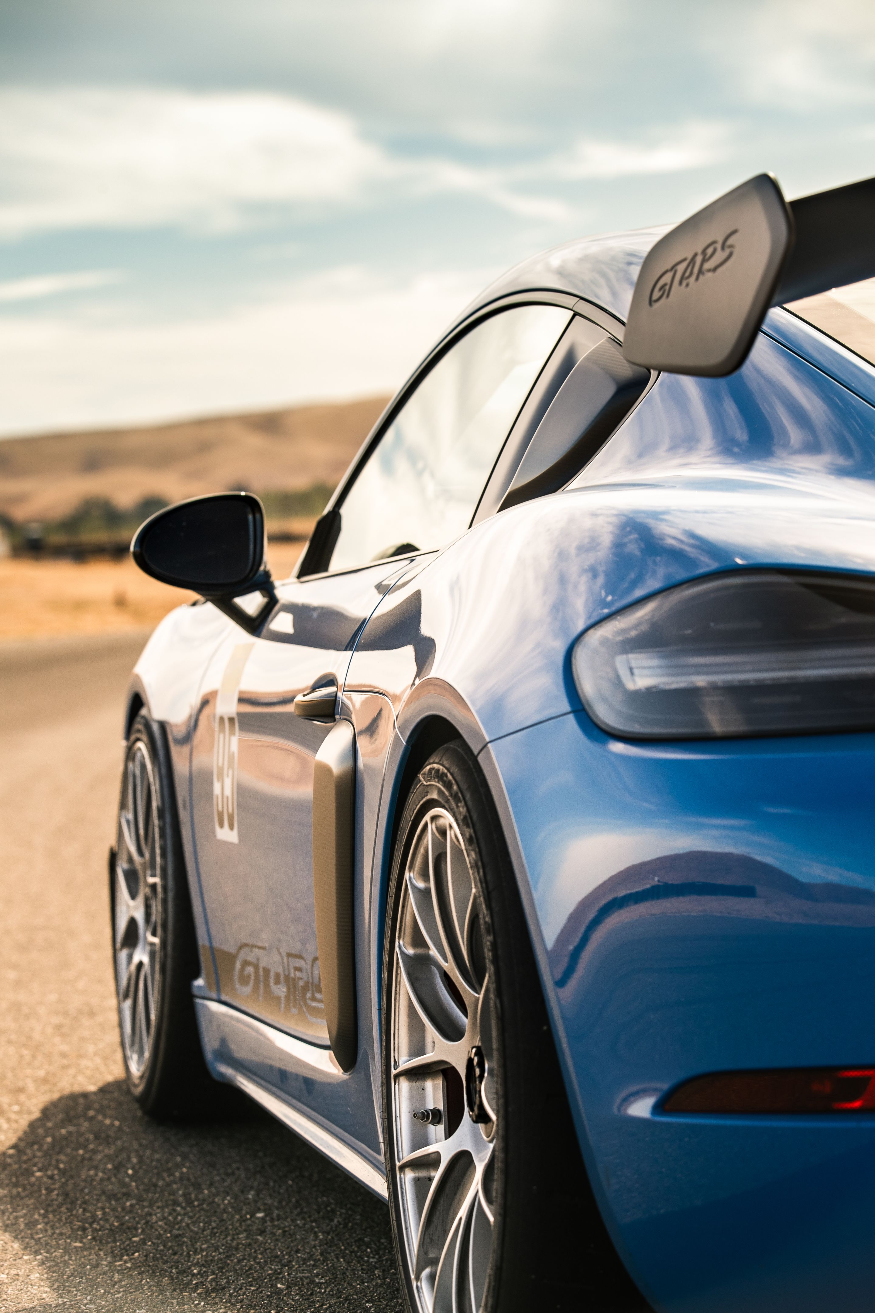 Blue Porsche 718 Cayman GT4 RS with 19" EC-7RS Apex wheels in Race Silver