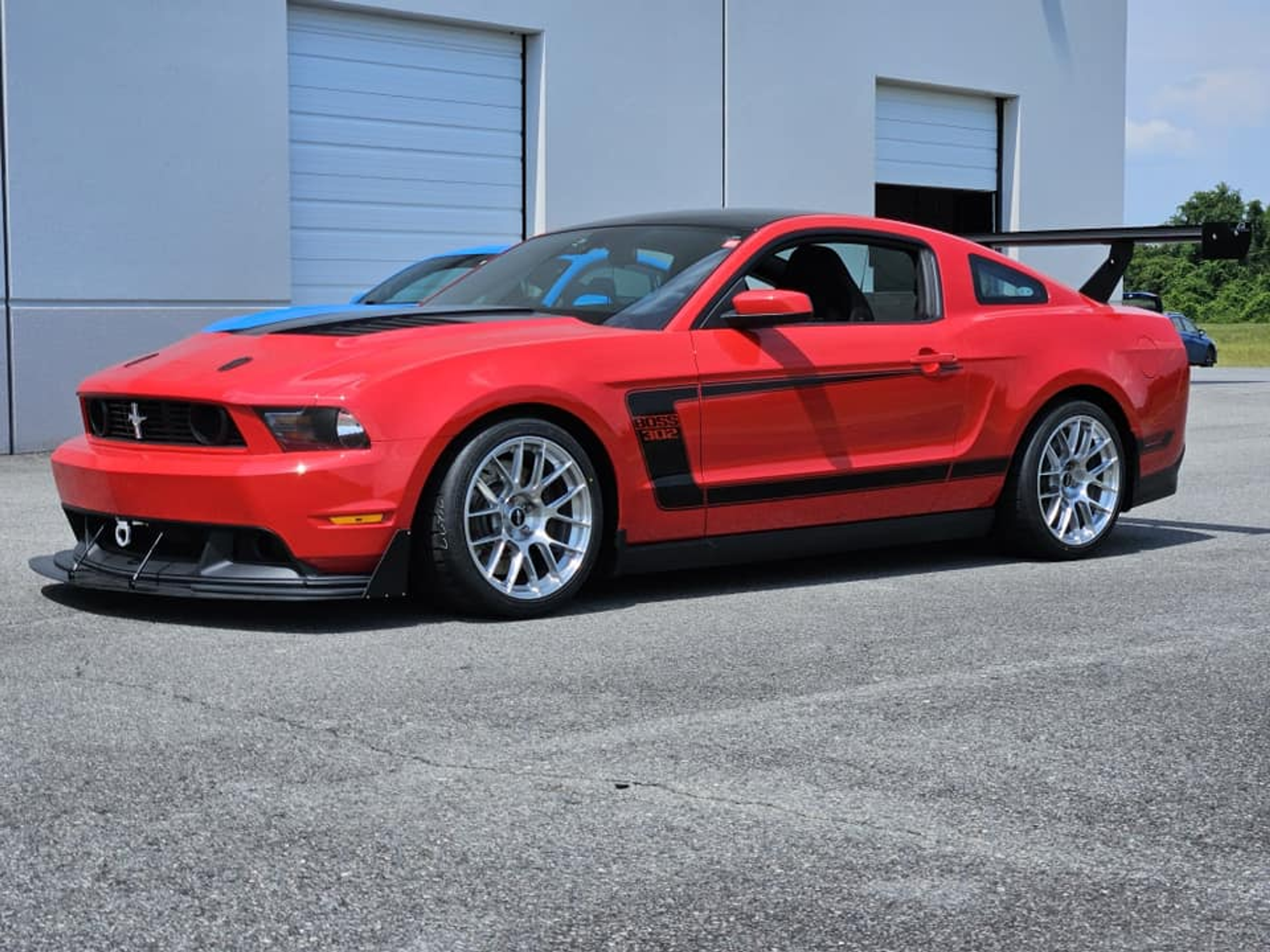 Red Ford S197 Mustang Boss 302 with 18" EC-7RS Apex wheels in Brushed Clear