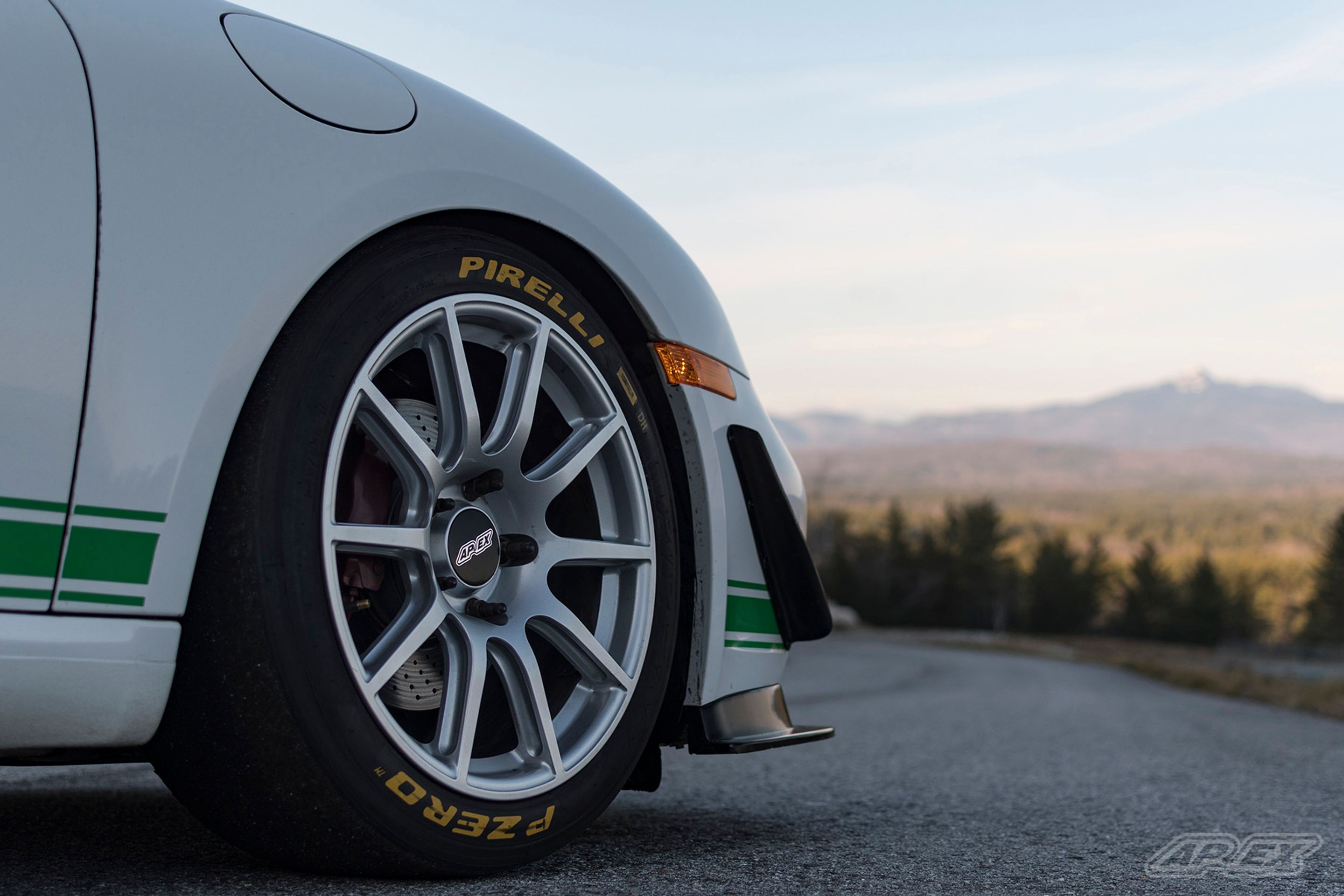 White Porsche 987 Cayman S with 18" SM-10 Apex wheels in Race Silver