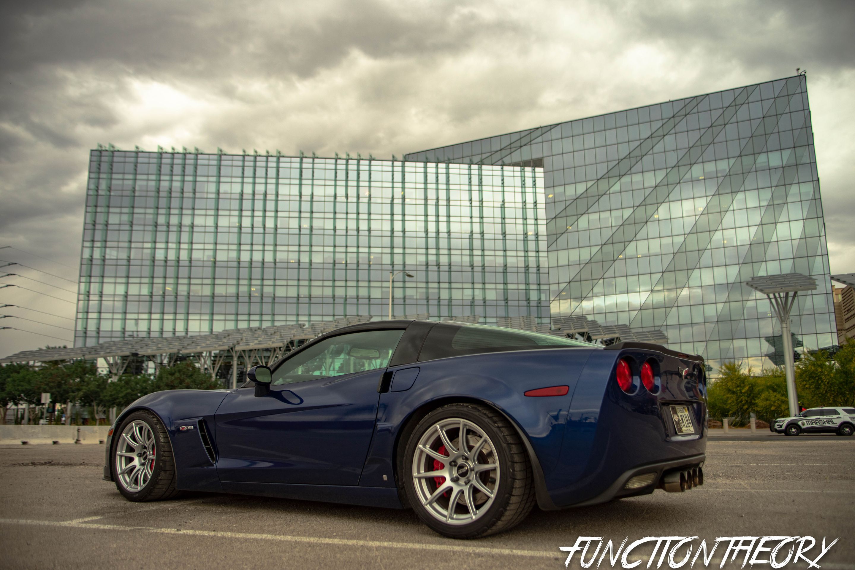 Blue Chevrolet C6 Corvette Z06 with 18" SM-10 Apex wheels in Race Silver