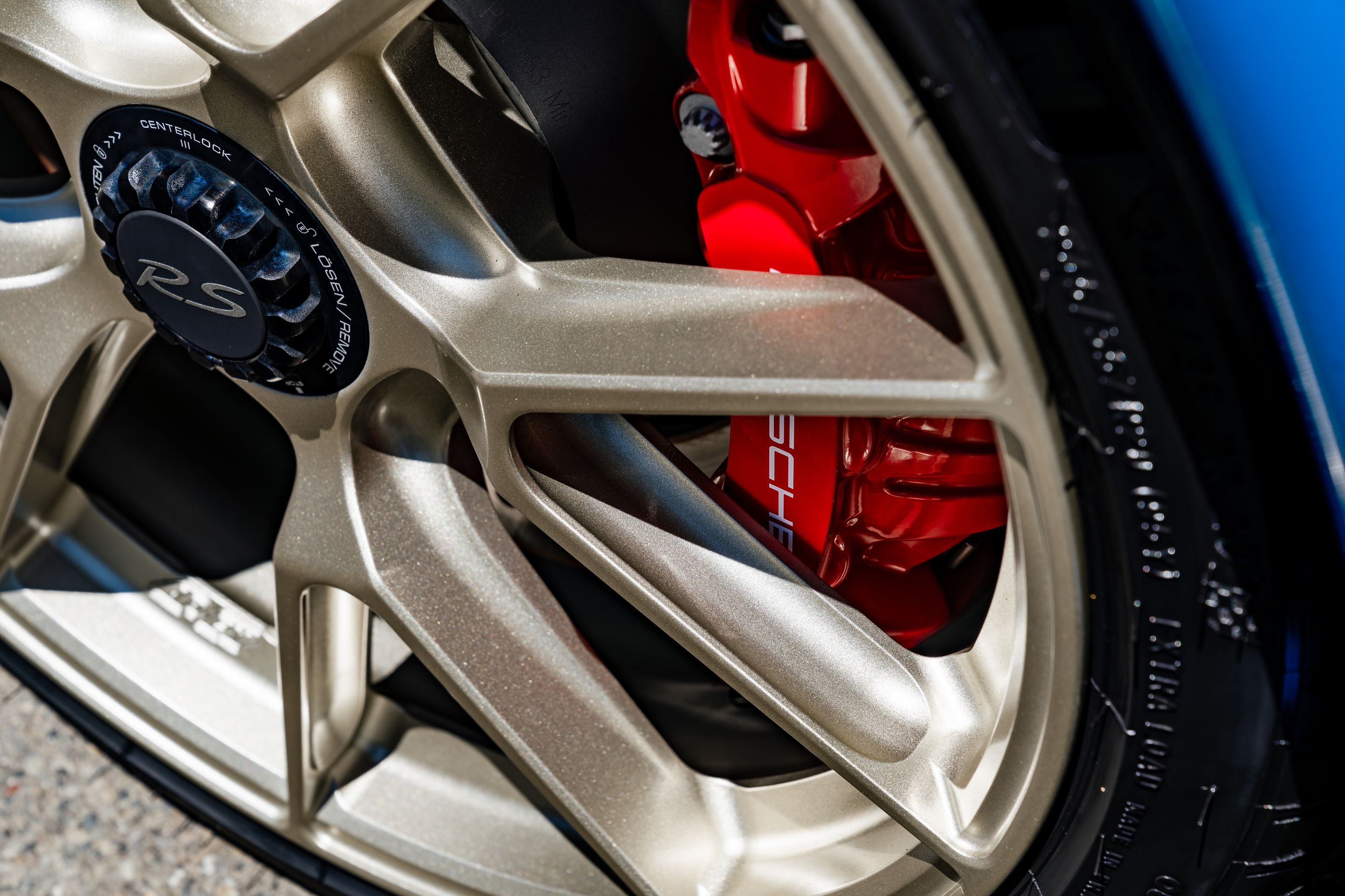 Blue Porsche 718 Cayman GT4 RS with 20" VS-5RS Apex wheels in Motorsport Gold