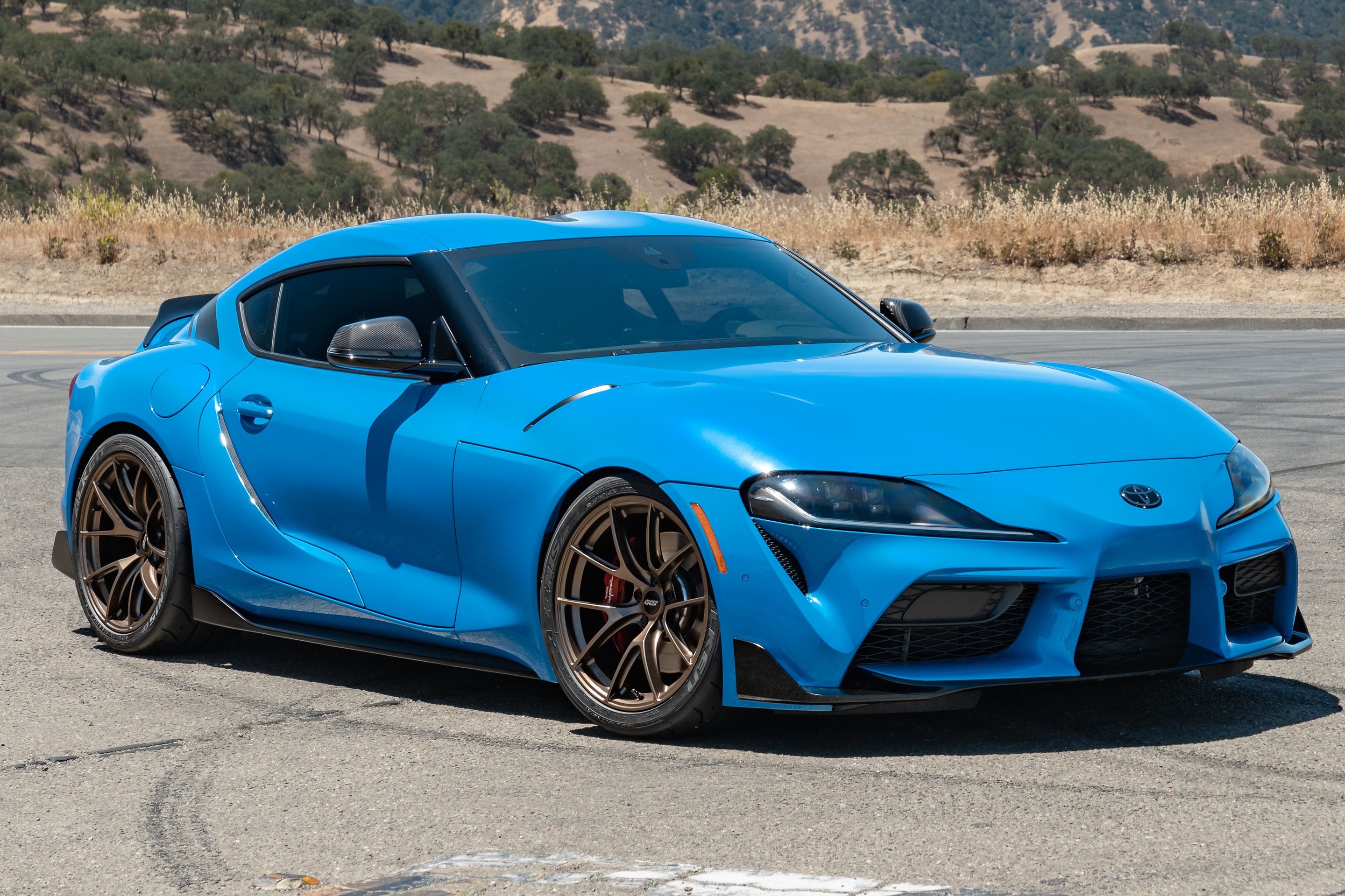 Blue Toyota GR Supra with 19" VS-5RS Apex wheels in Satin Bronze