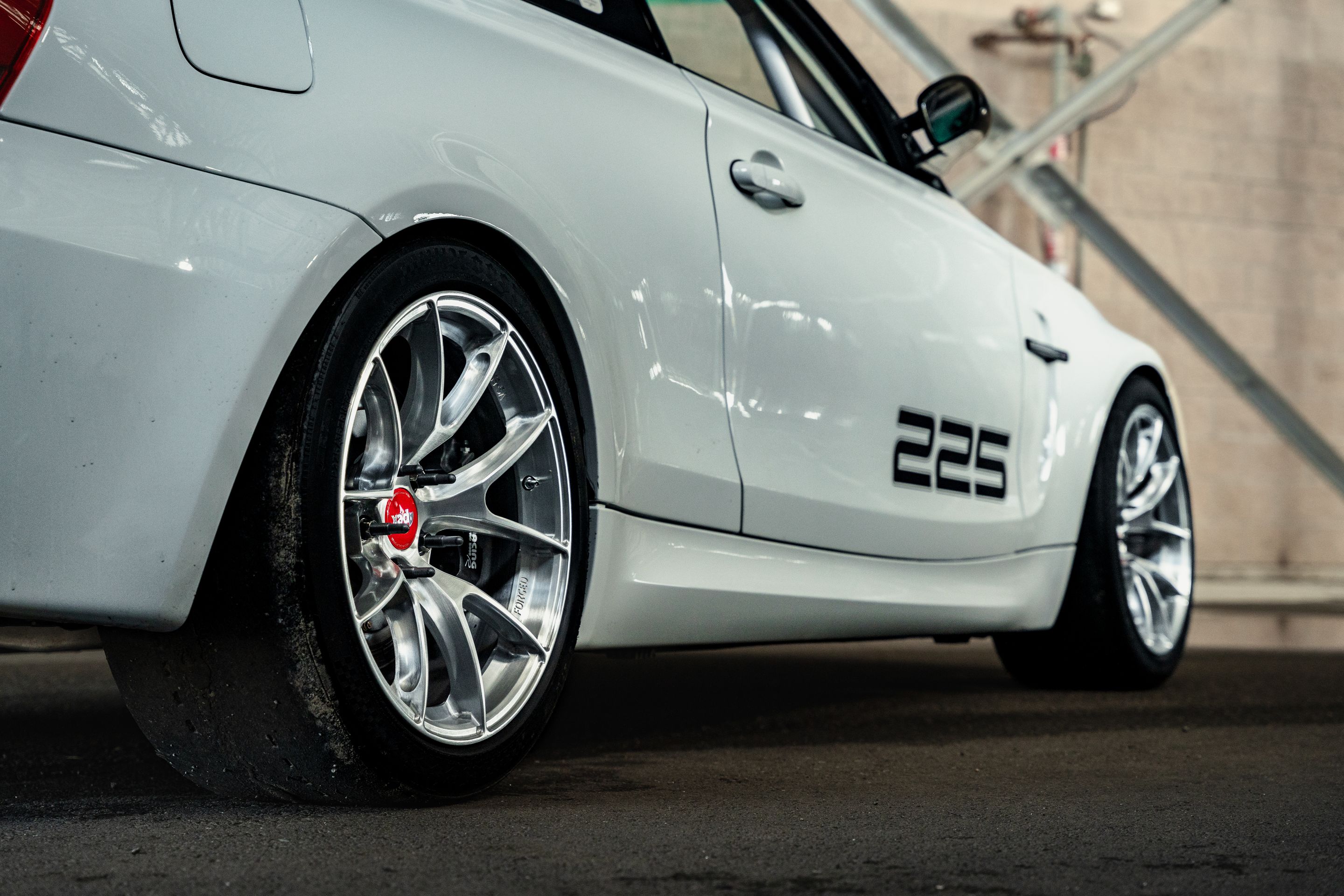 White BMW E82 1M with 18" VS-5RS Apex wheels in Brushed Clear