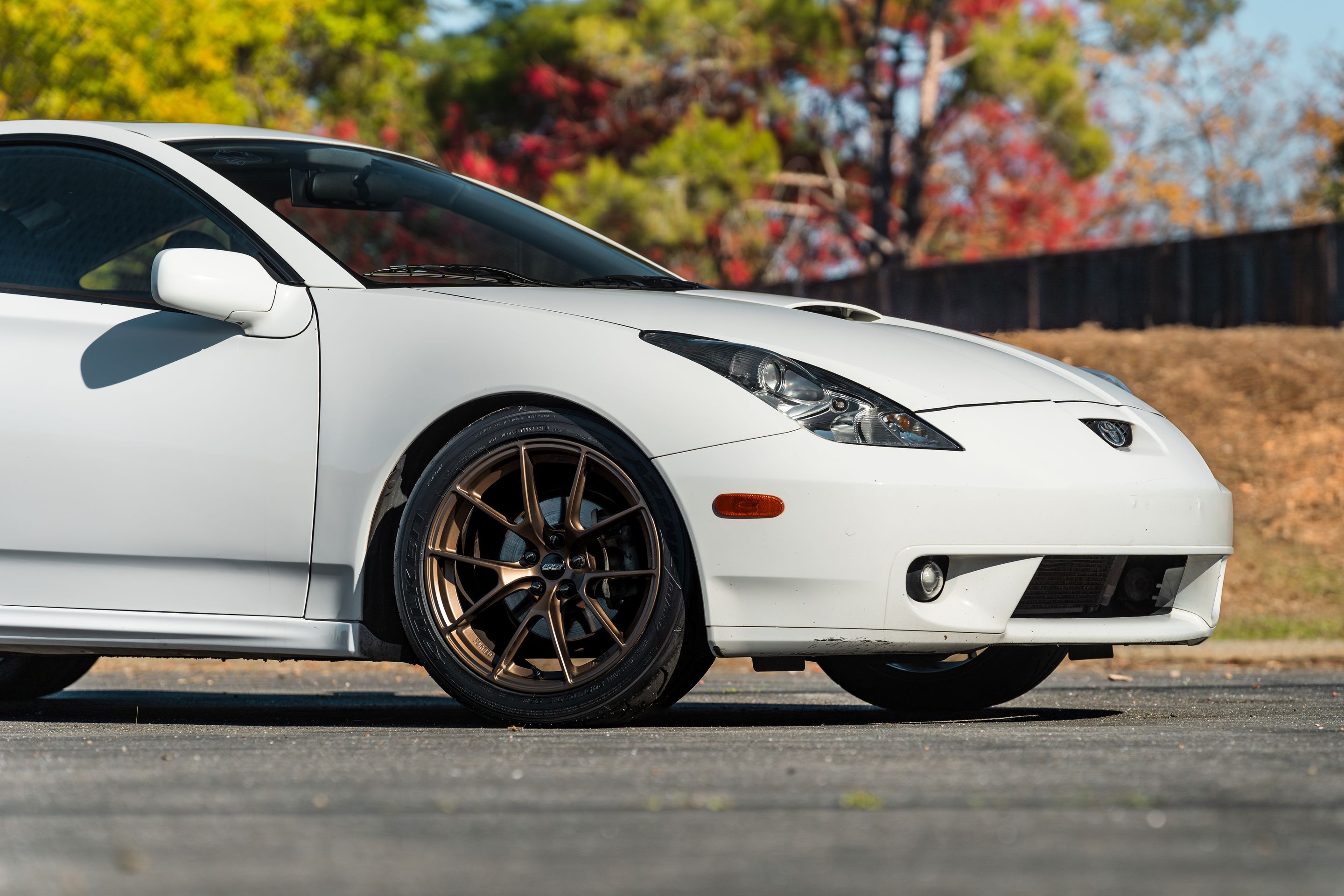 White Toyota 7th Gen Celica with 17" VS-5RS Apex wheels in Satin Bronze