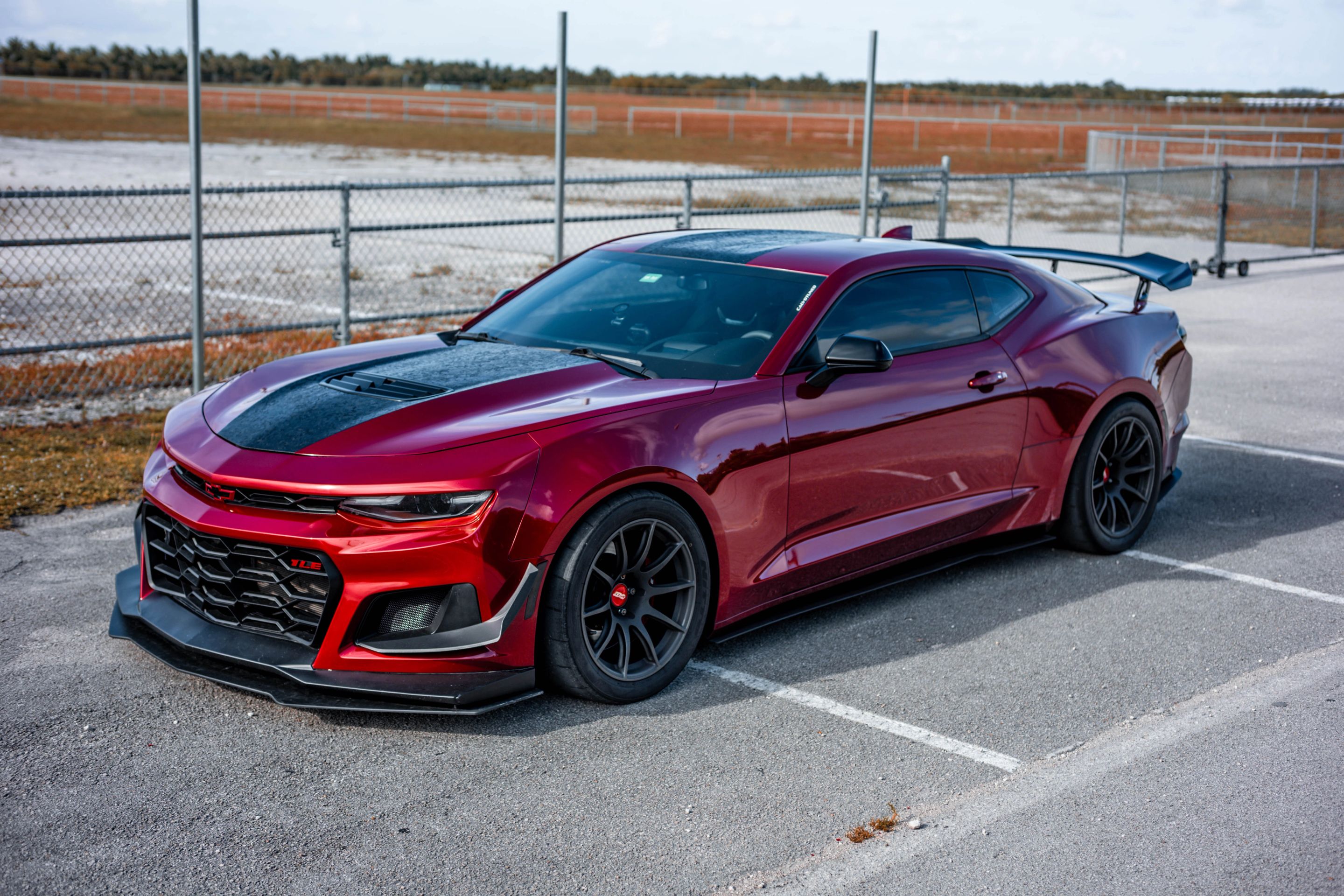 Red Chevrolet 6th Gen Camaro SS with 19" SM-10 Apex wheels in Satin Black