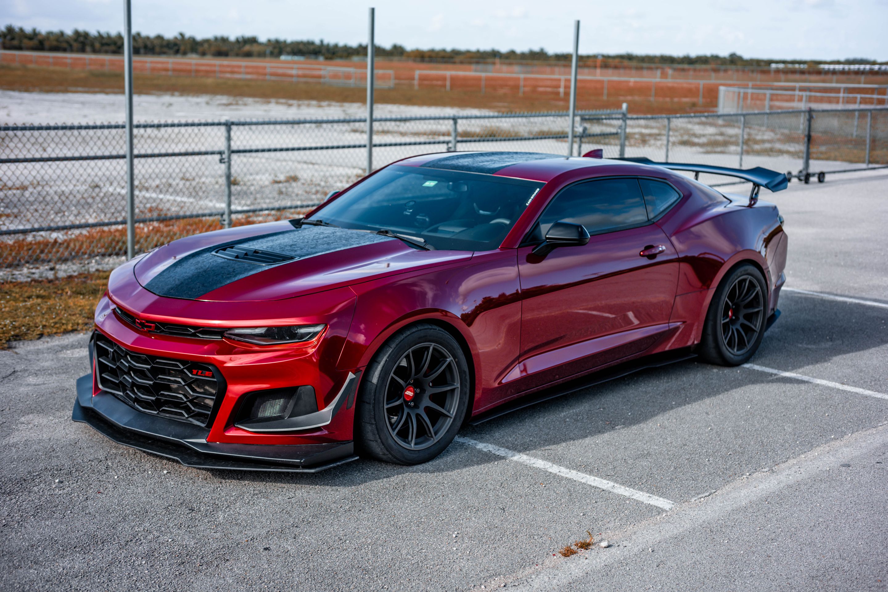 Red Chevrolet 6th Gen Camaro SS with 19" SM-10 Apex wheels in Satin Black