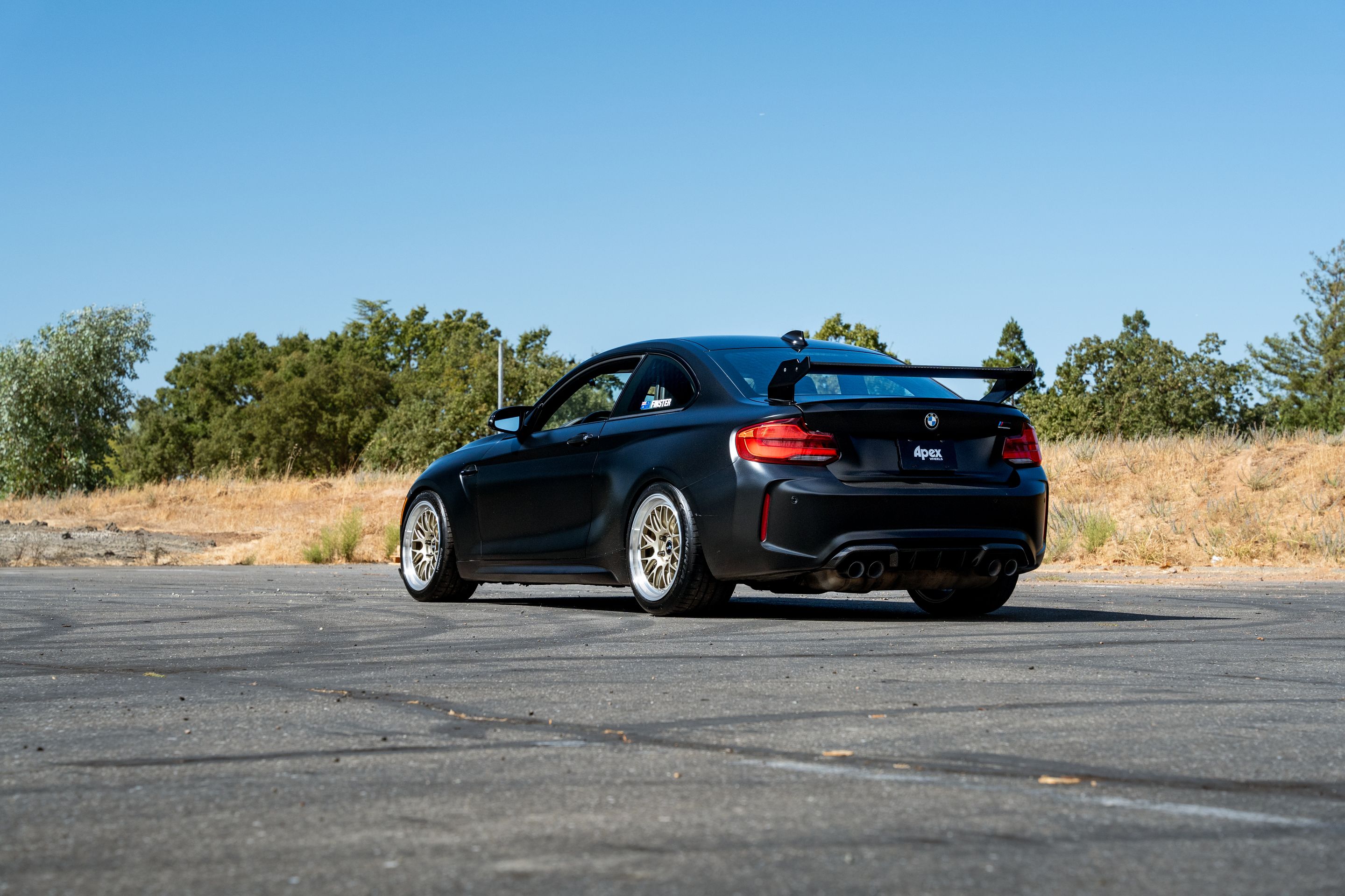 Black BMW F87 M2 with 18" ML-10RT Apex wheels in Machined Lip Gloss Motorsport Gold