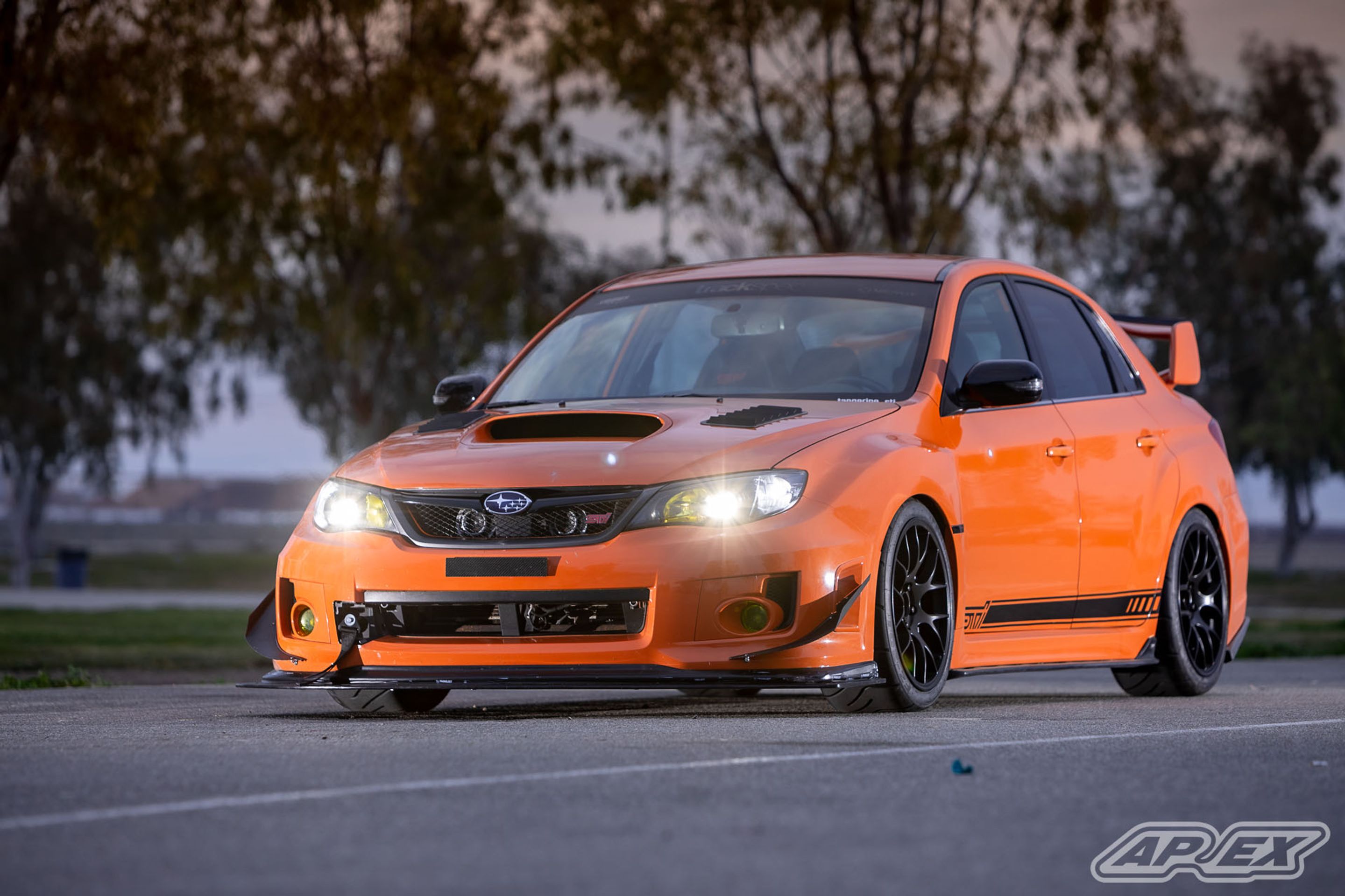 Orange Subaru GR WRX STI with 18" EC-7 Apex wheels in Satin Black