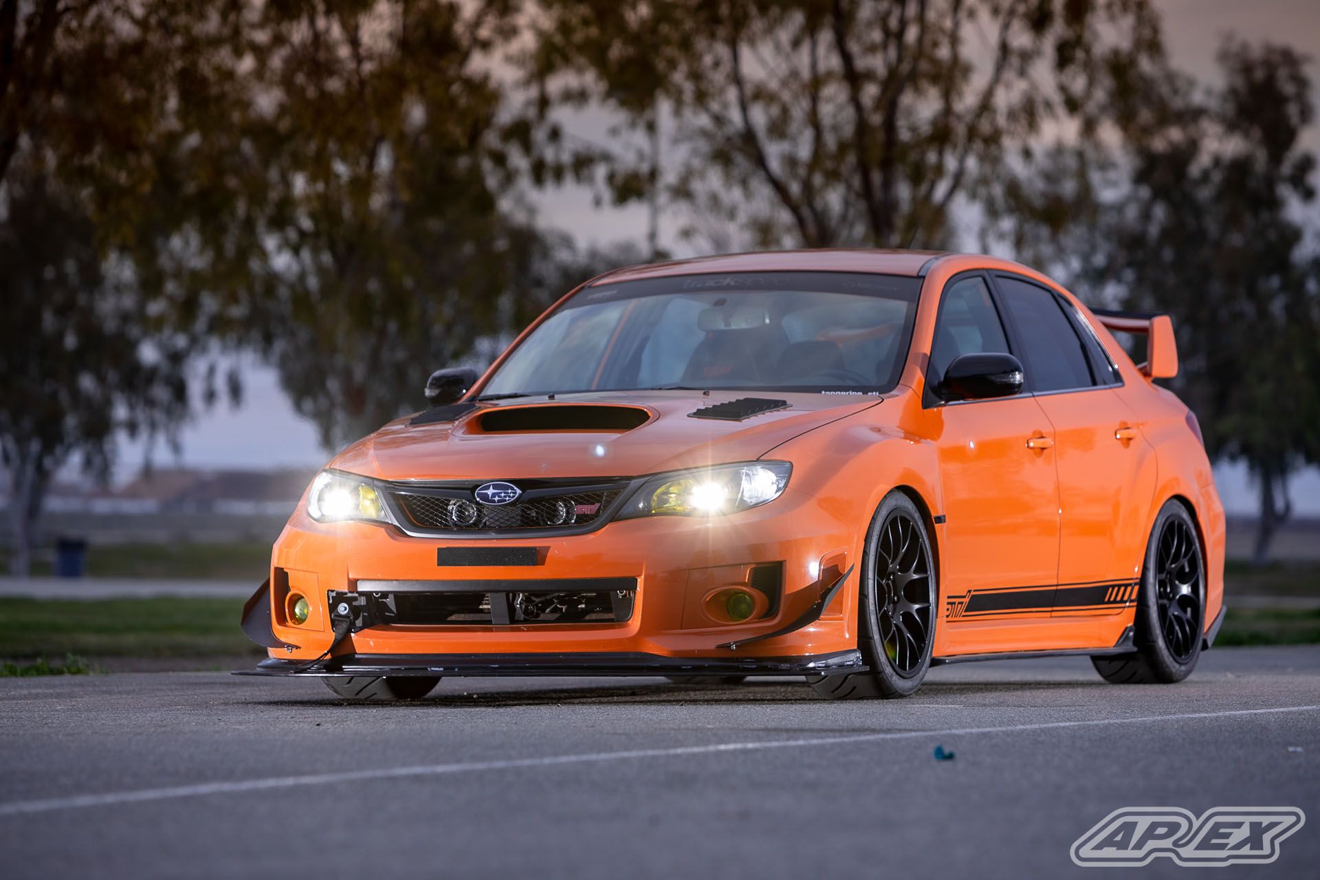 Orange Subaru GR WRX STI with 18" EC-7 Apex wheels in Satin Black