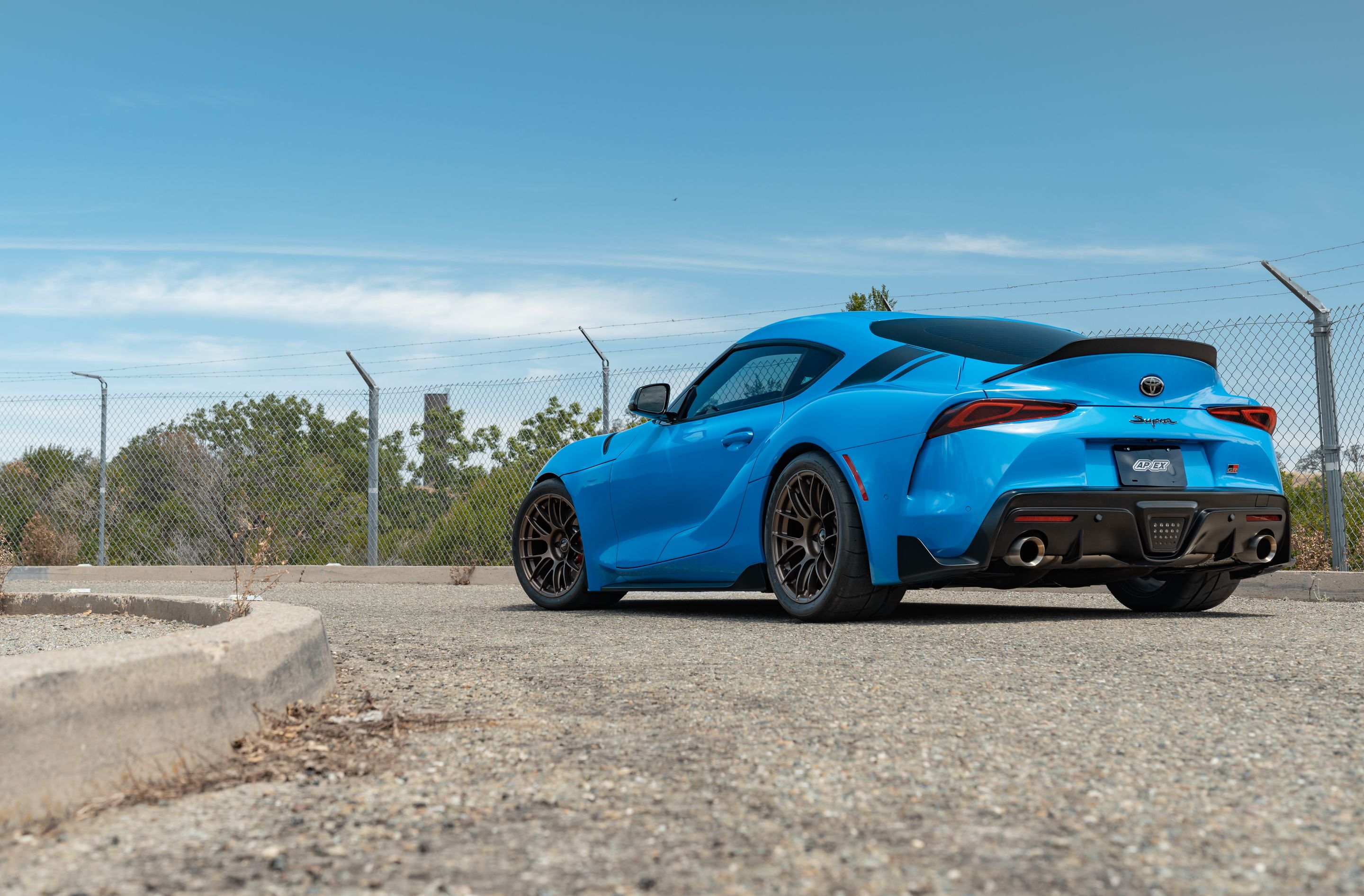 Blue Toyota GR Supra with 18" EC-7RS Apex wheels in Satin Bronze