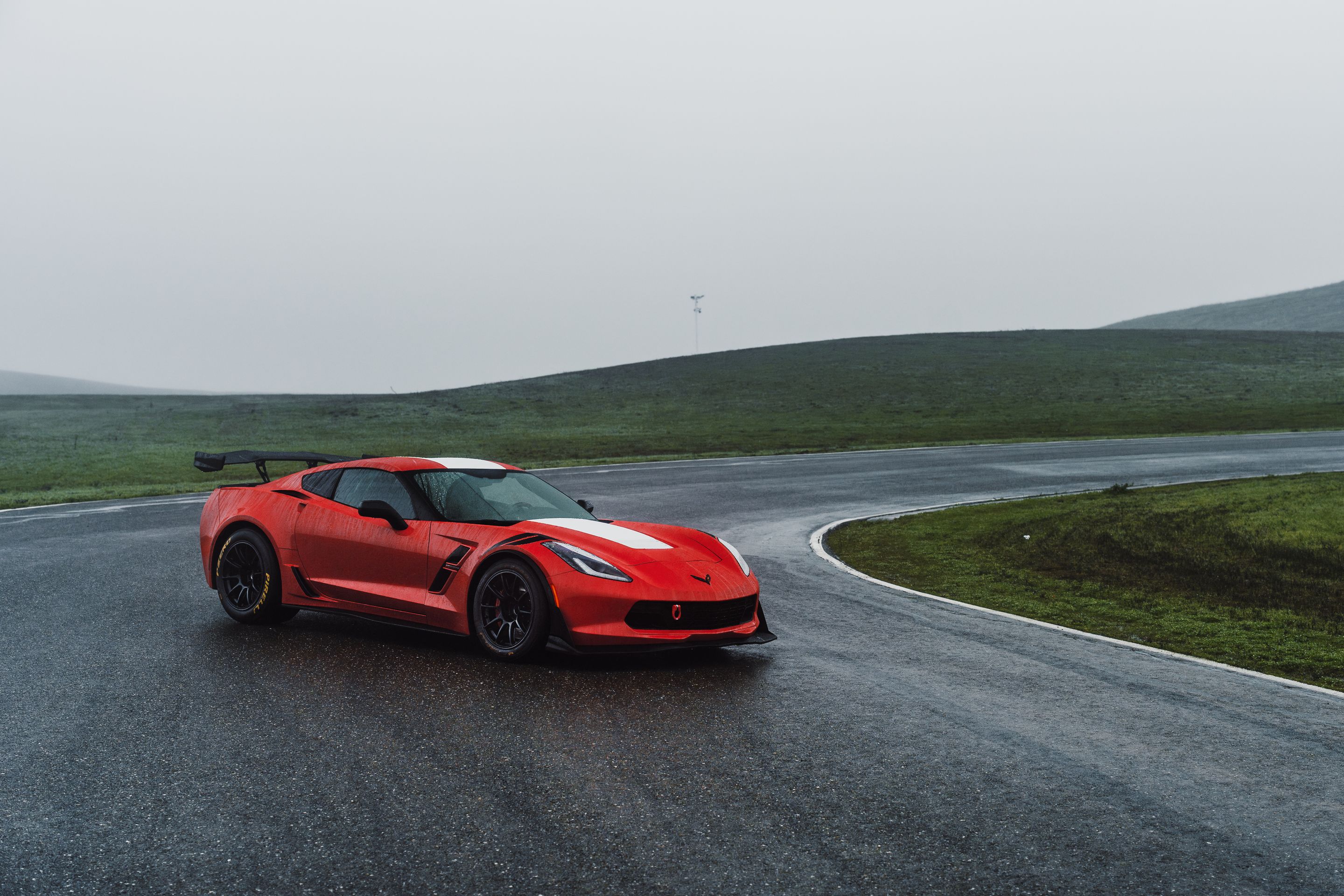 Red Chevrolet C7 Corvette Grand Sport with 18" SM-10RE Apex wheels in Satin Black