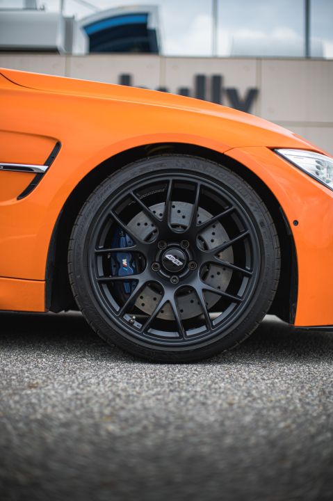 Orange BMW F80 M3 with 19" EC-7 Apex wheels in Satin Black