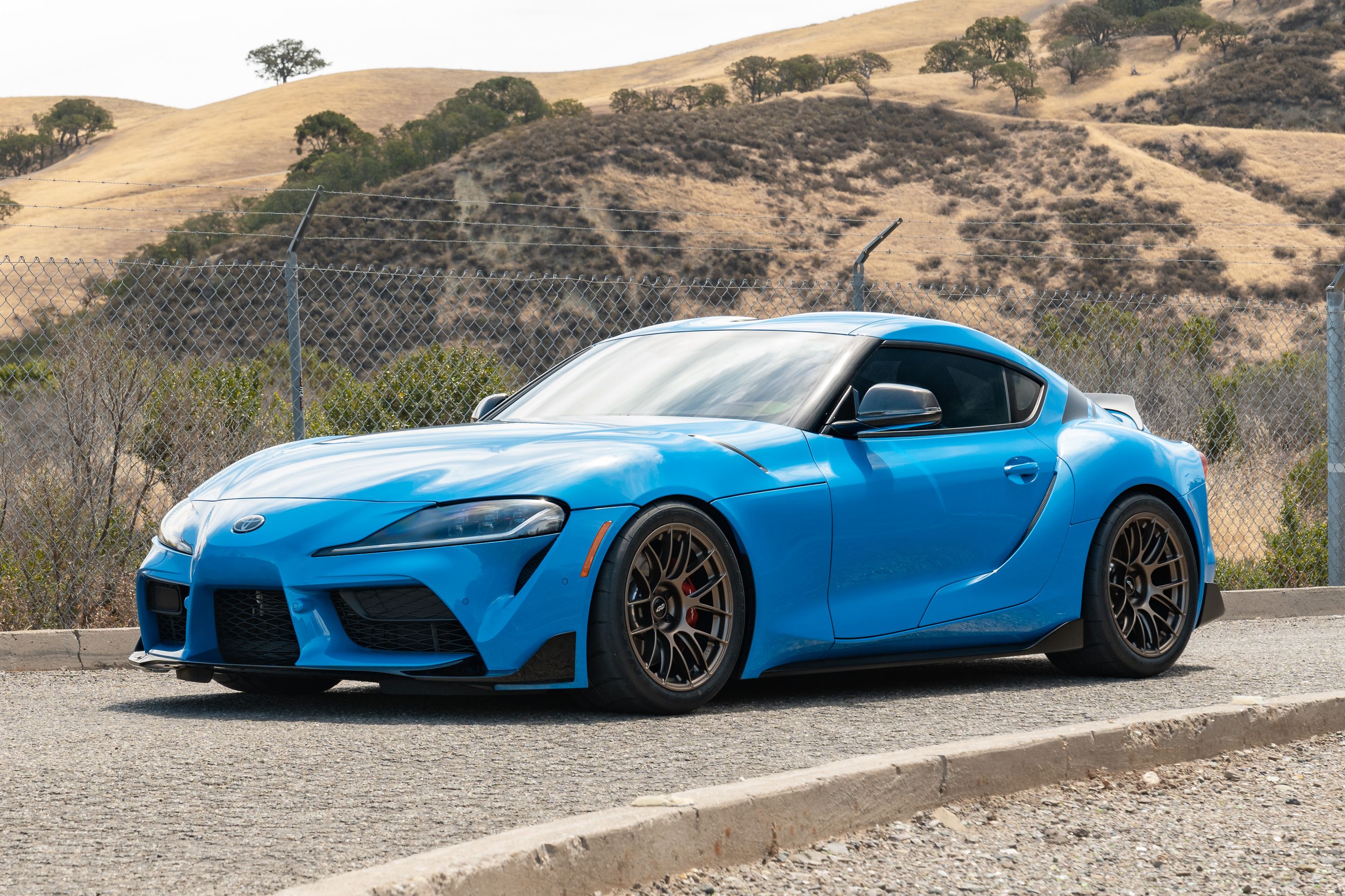 Blue Toyota GR Supra with 18" EC-7RS Apex wheels in Satin Bronze