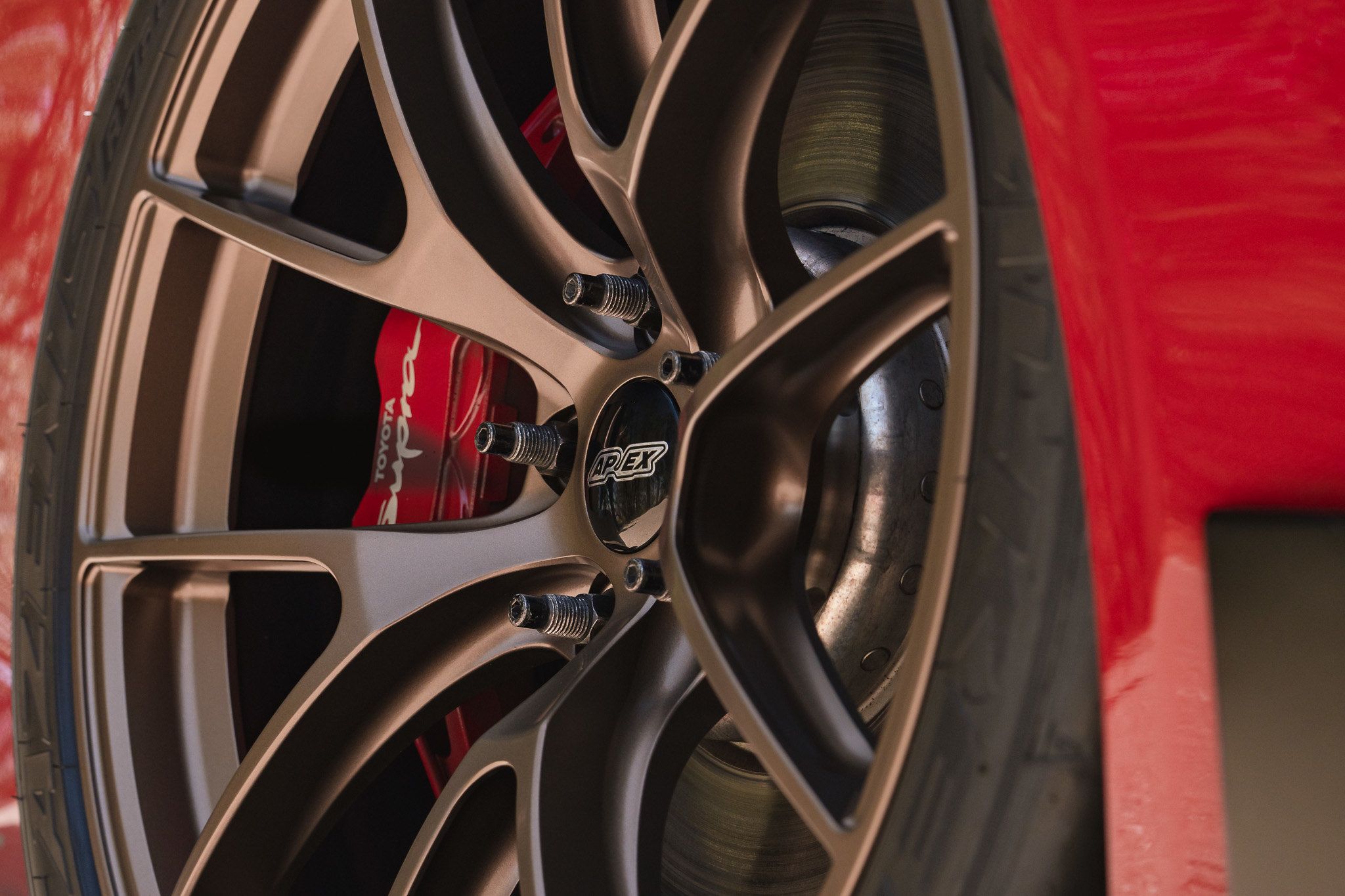 Red Toyota GR Supra with 19" VS-5RS Apex wheels in Satin Bronze
