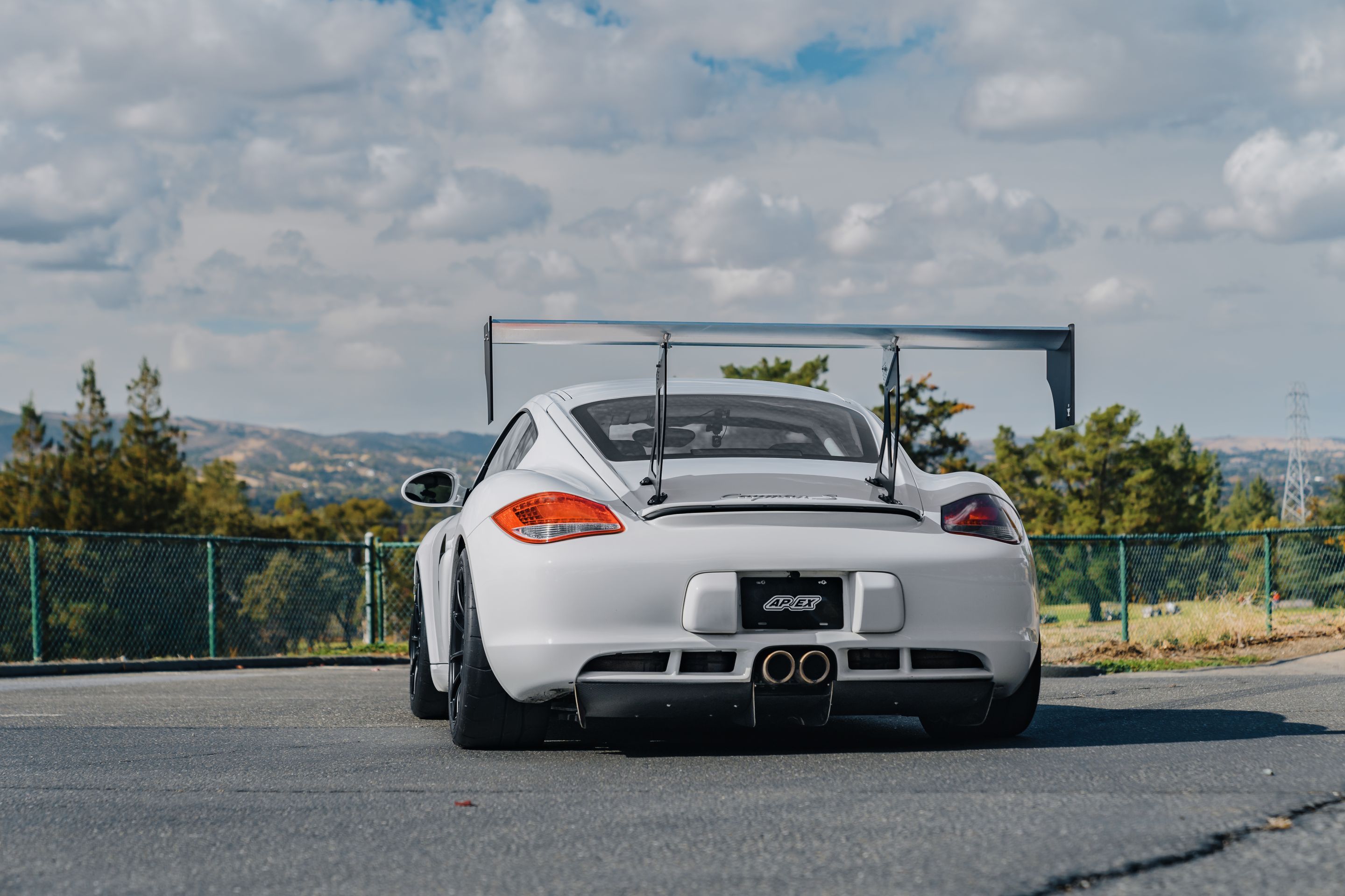 White Porsche 987 Cayman S with 18" SM-10RS Apex wheels in Satin Black