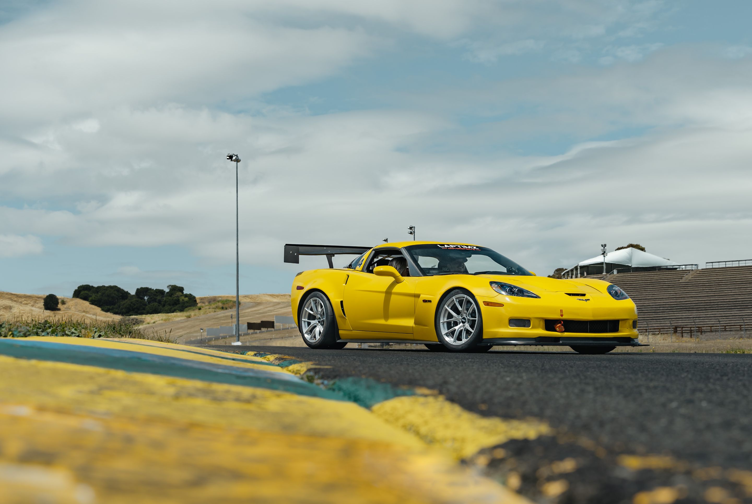 Yellow Chevrolet C6 Corvette Z06 with 18" VS-5RS Apex wheels in Brushed Clear