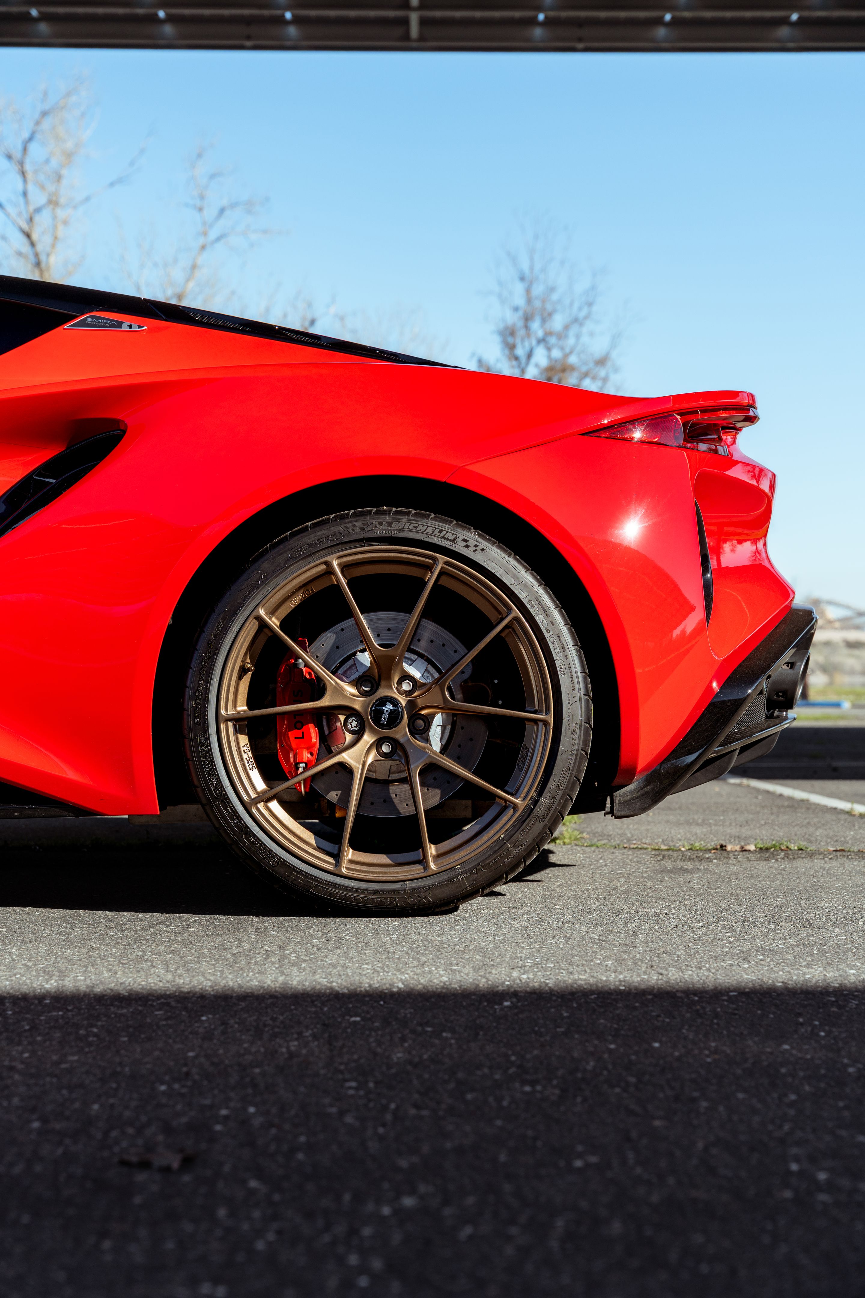 Red Lotus Emira with 20" VS-5RS Apex wheels in Anthracite