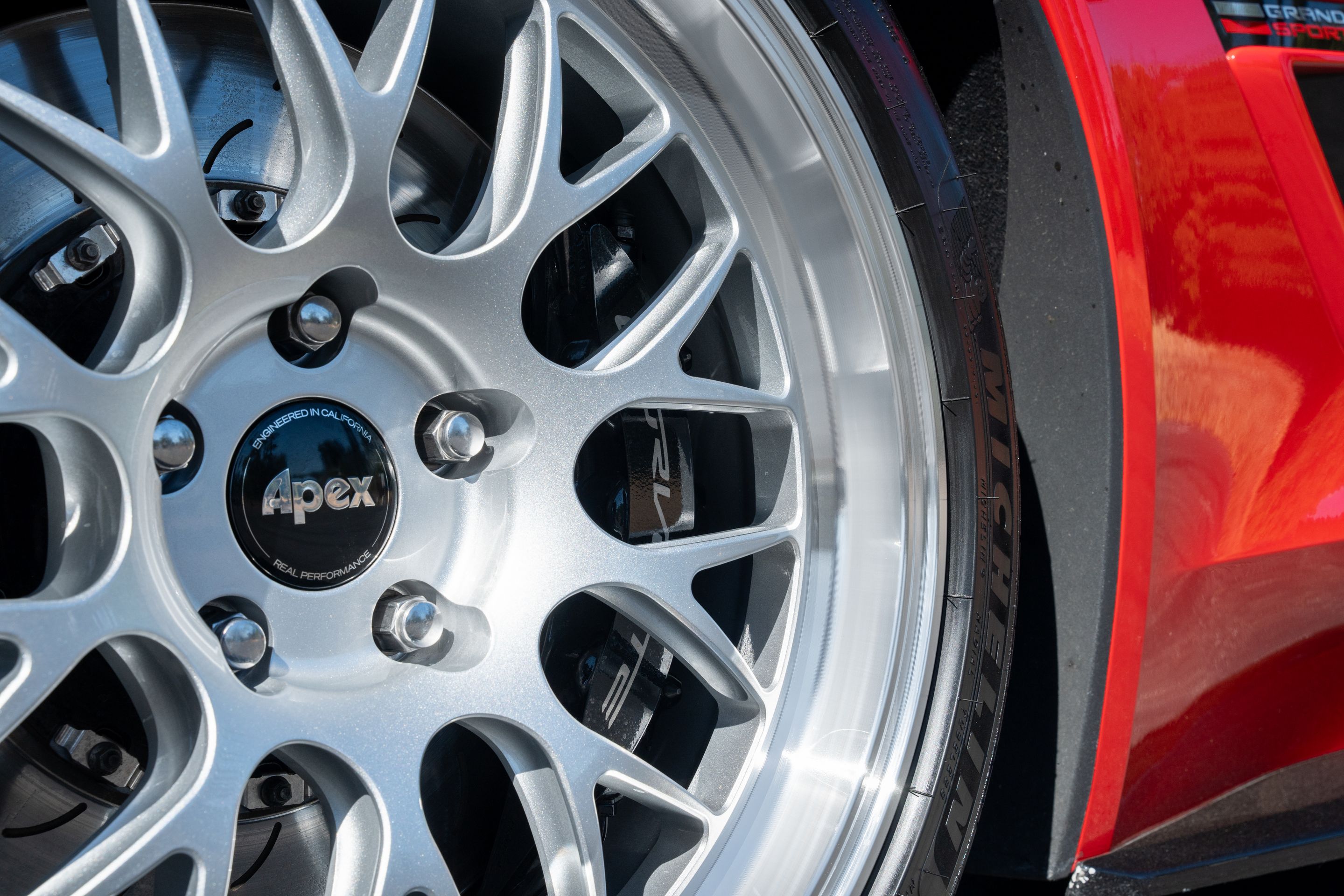 Red Chevrolet C7 Corvette Grand Sport with 18"/19" ML-10RT Apex wheels in Machined Lip Race Silver