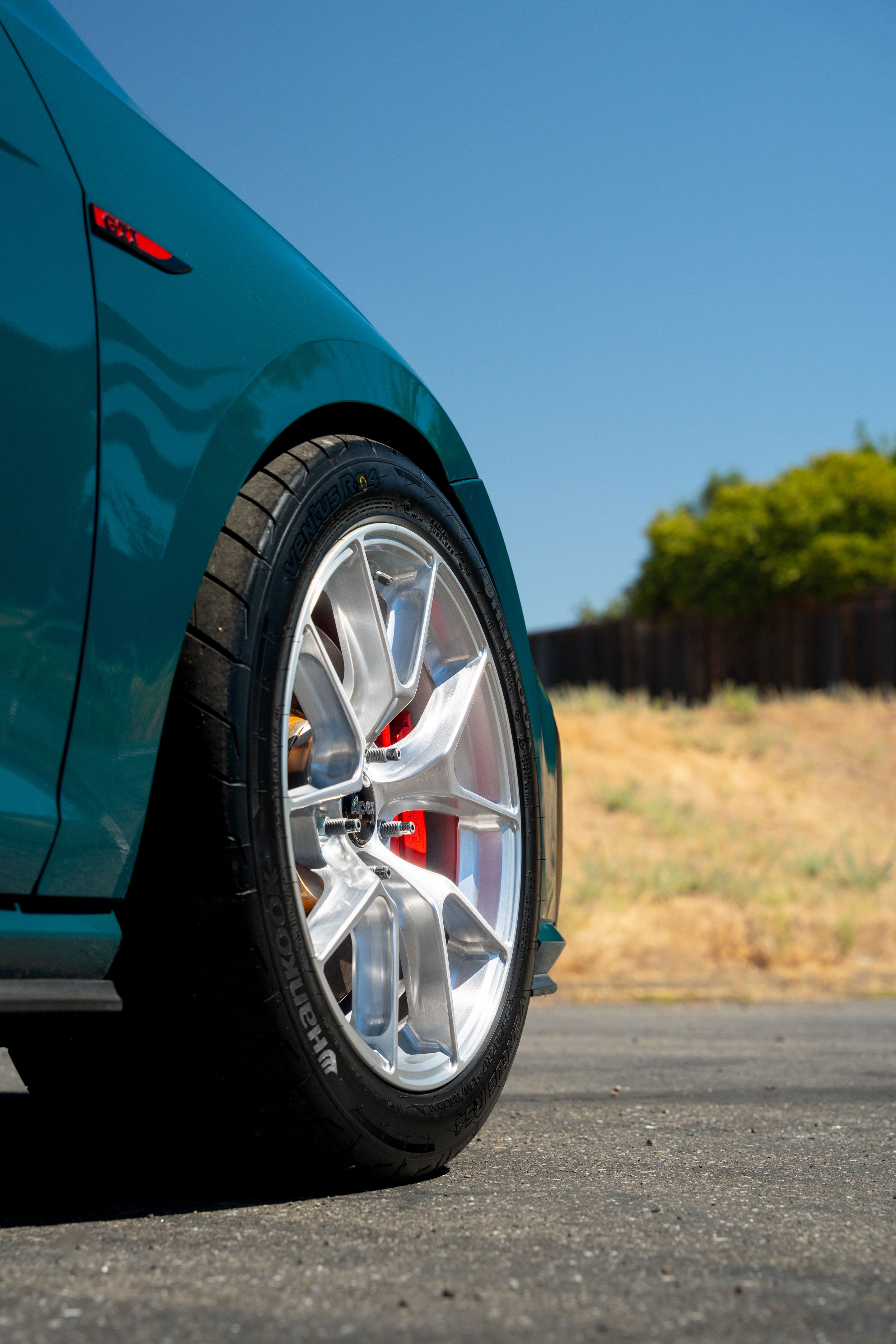 Green VW MK7 GTI with 17" VS-5RS Apex wheels in Brushed Clear