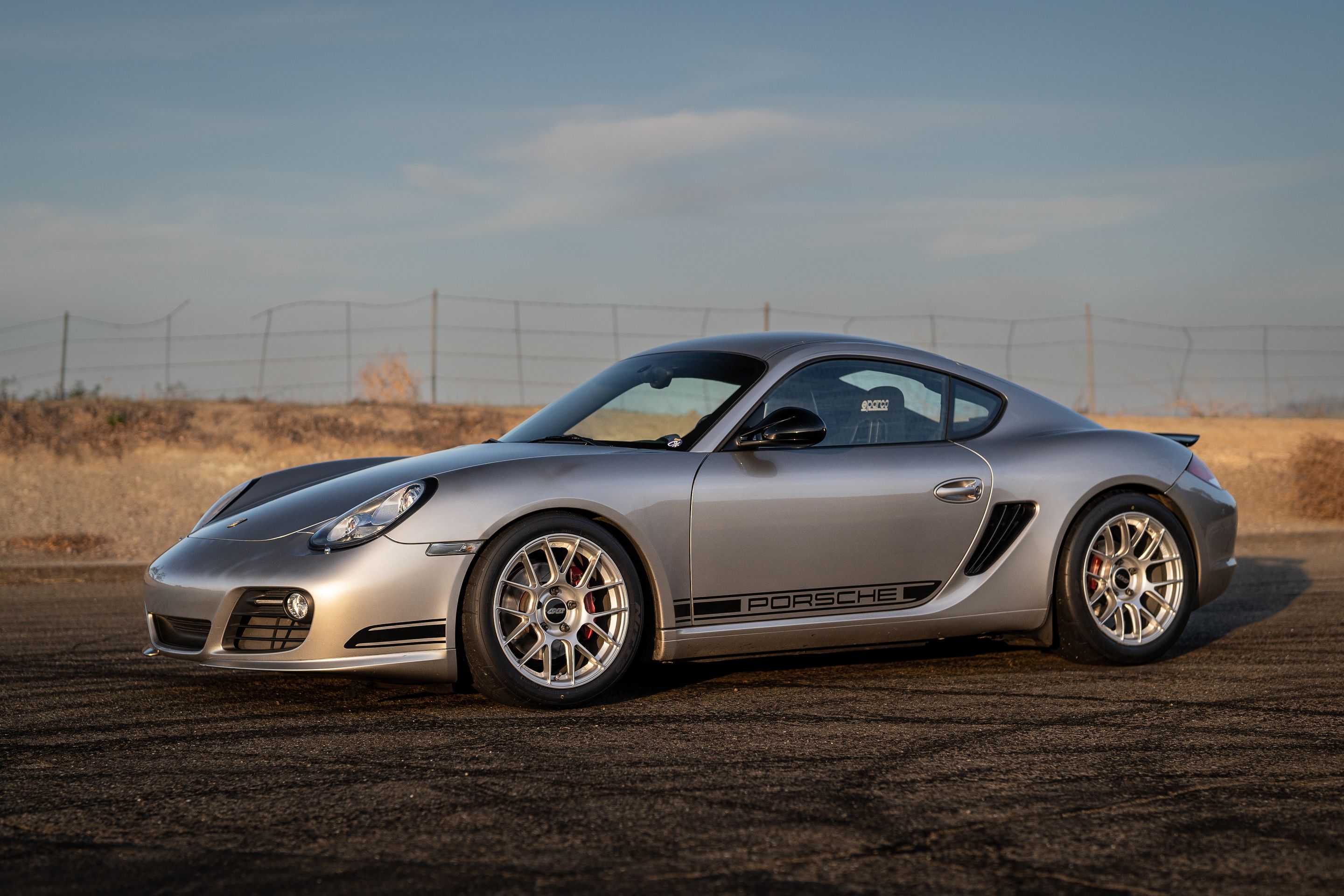 Grey Porsche 987 Cayman R with 18" EC-7RS Apex wheels in Race Silver