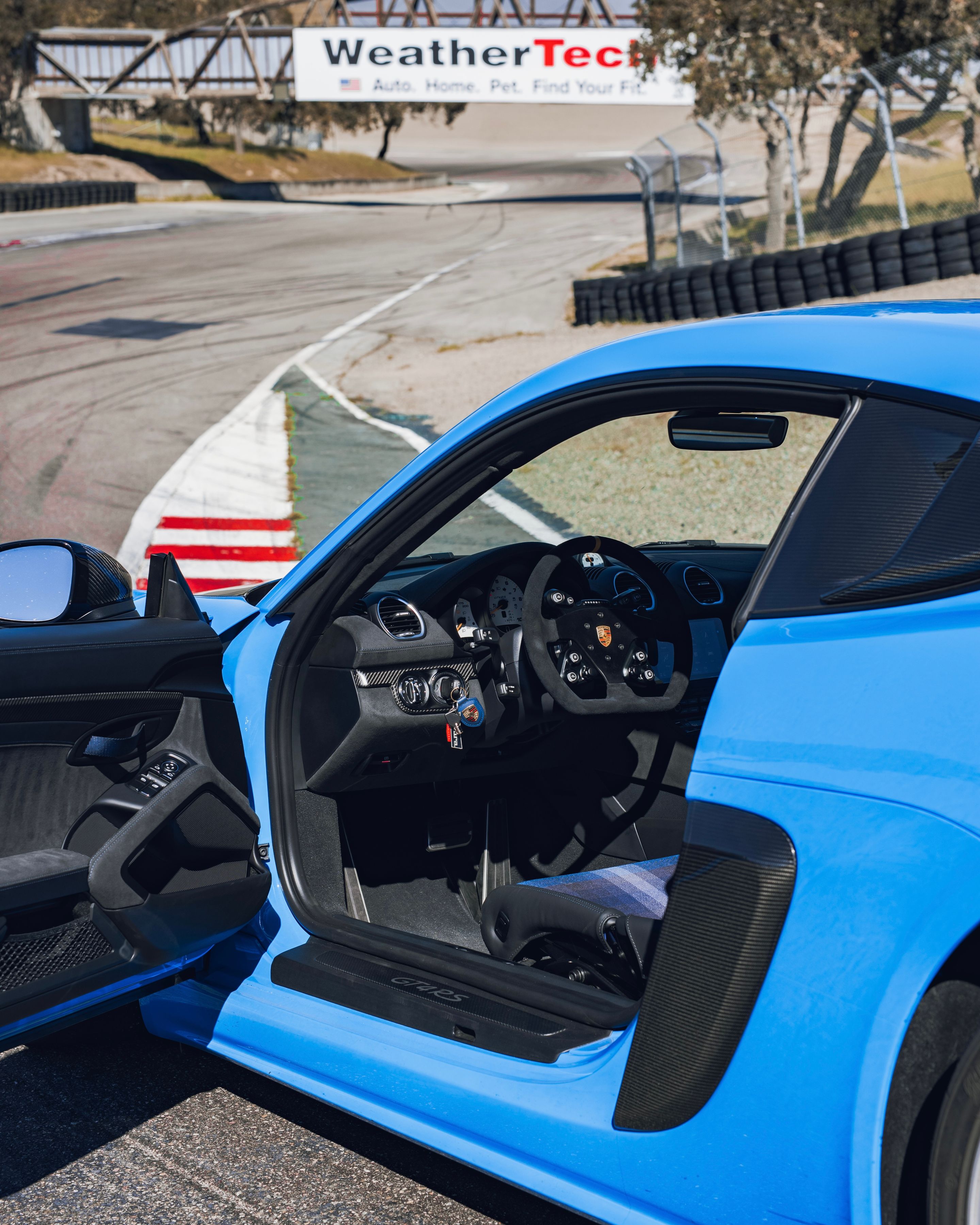 Blue Porsche 718 Cayman GT4 RS with 19" EC-7RS Apex wheels in Race Silver