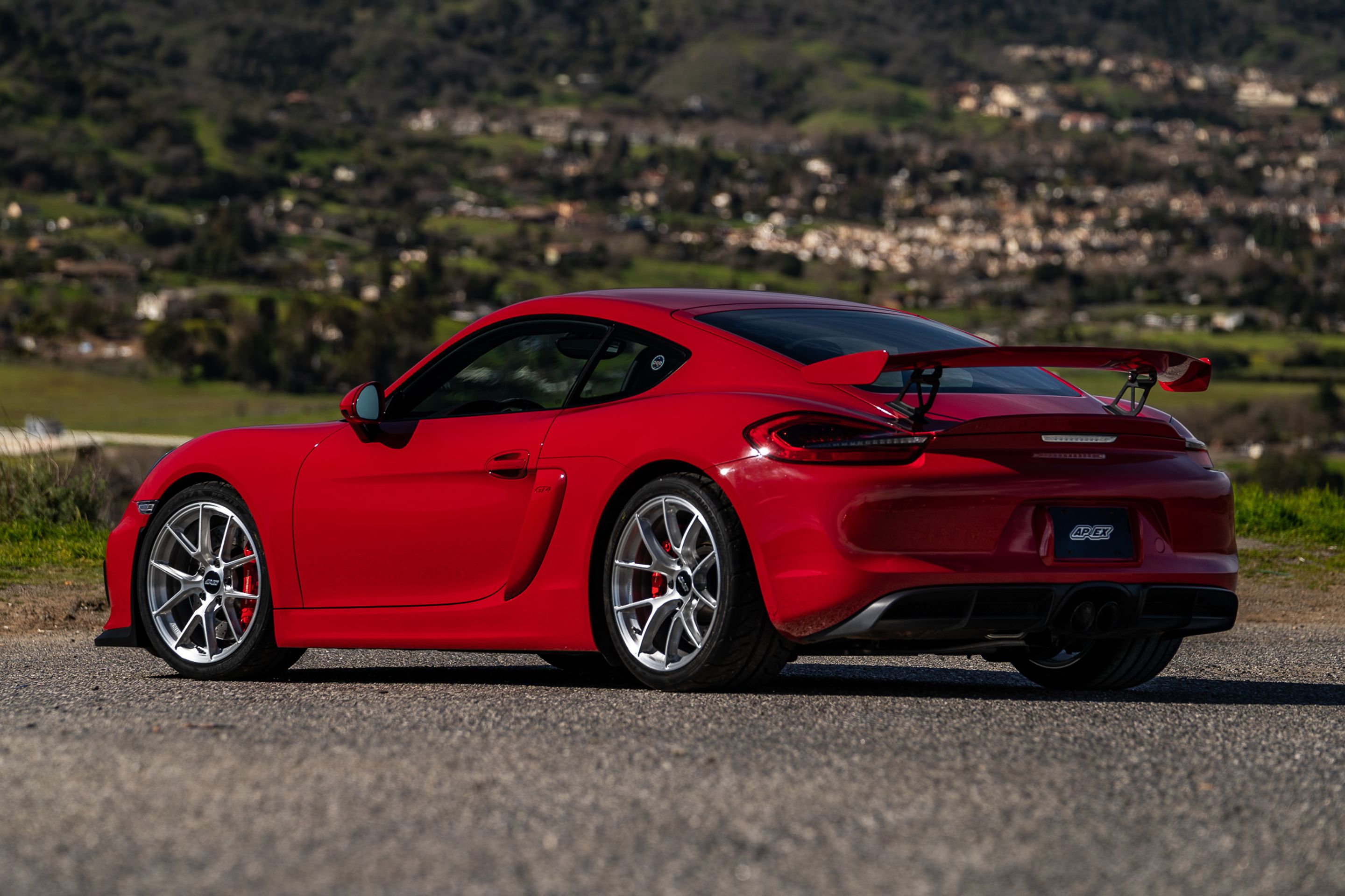 Red Porsche 981 Cayman GT4 with 19" VS-5RS Apex wheels in Brushed Clear