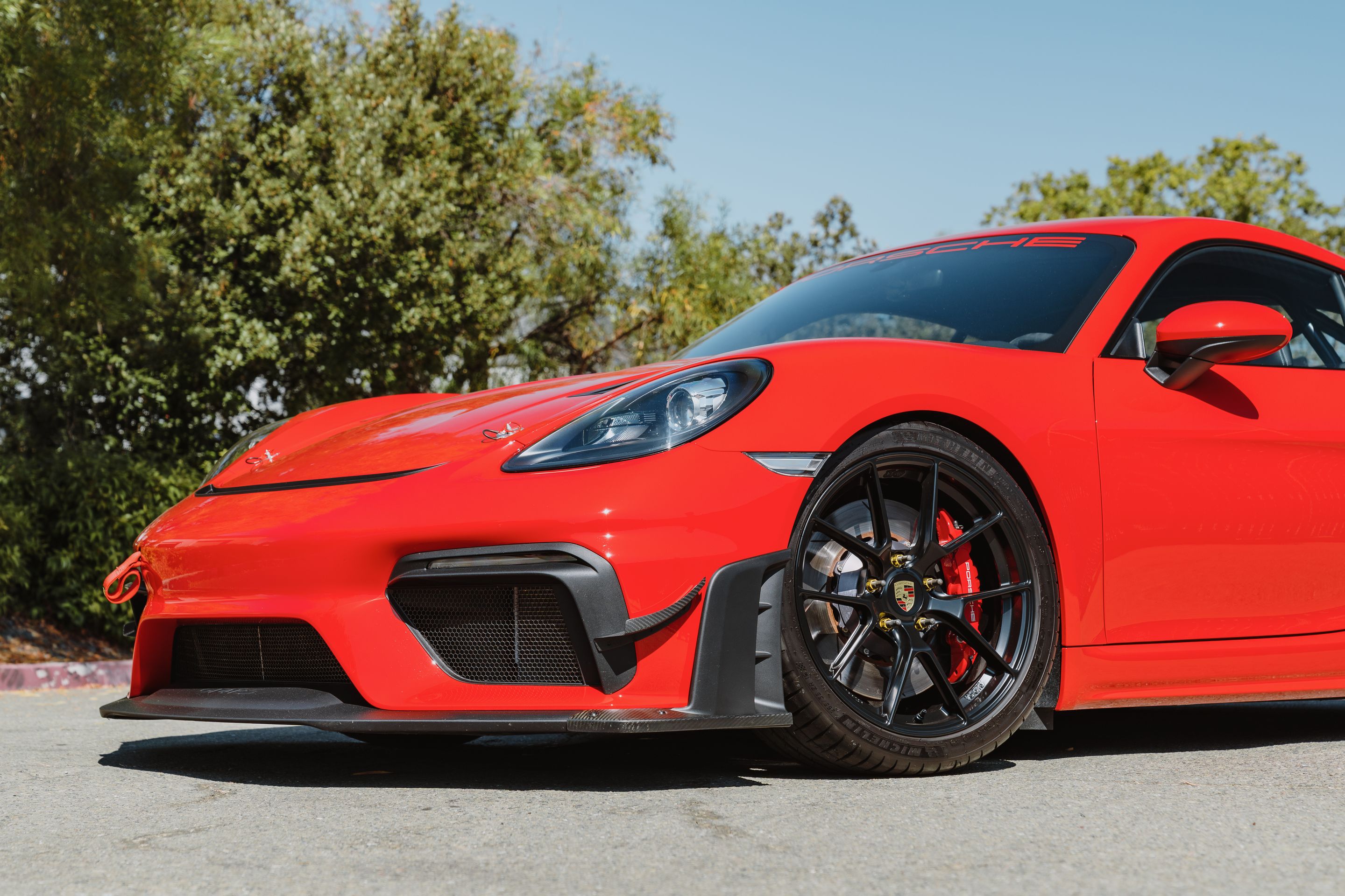 Red Porsche 718 Cayman GT4 with 19" VS-5RS Apex wheels in Satin Black