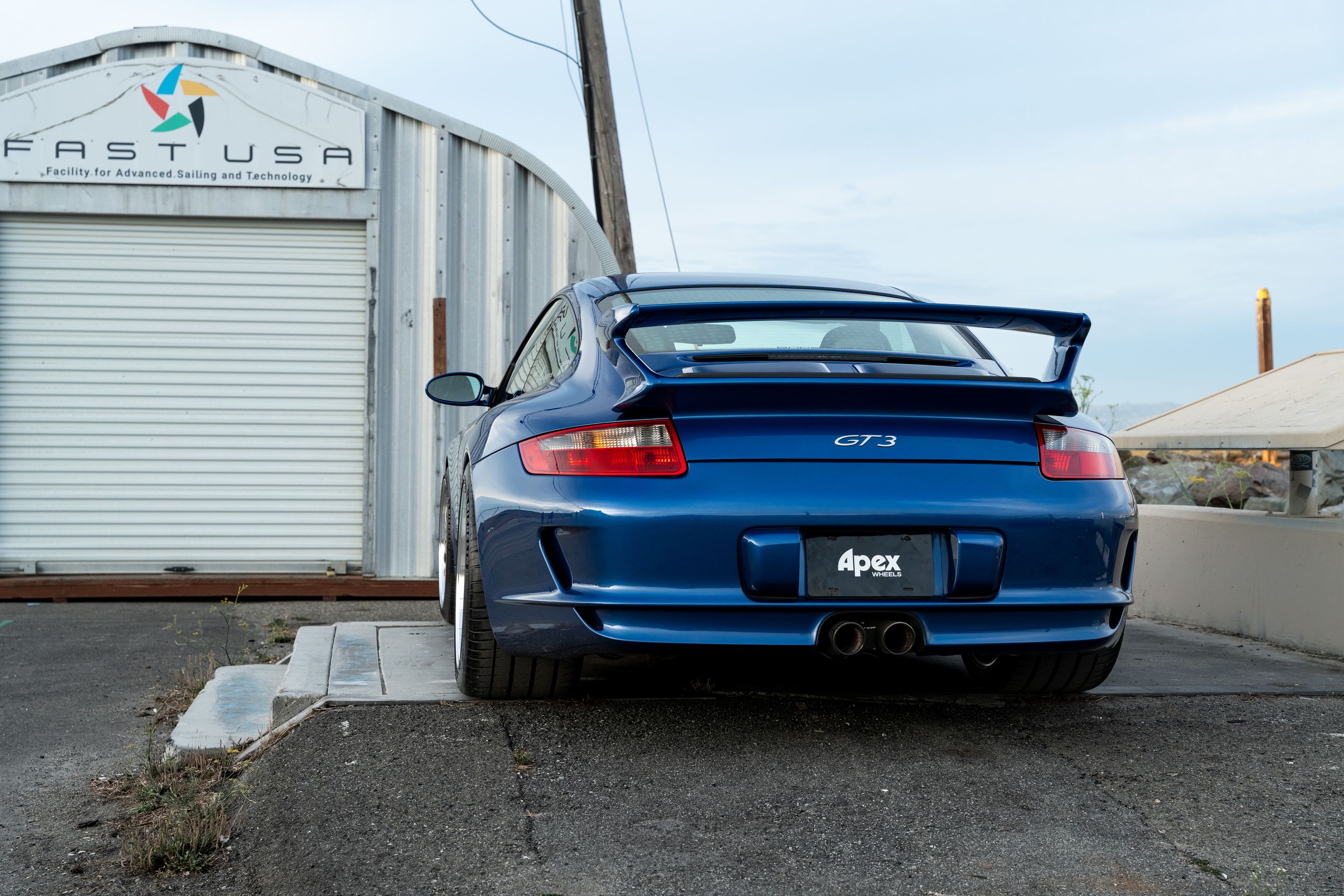 Blue Porsche 911 997 GT3 with 19" TEST-M Apex wheels in Machined Lip Gloss Motorsport Gold