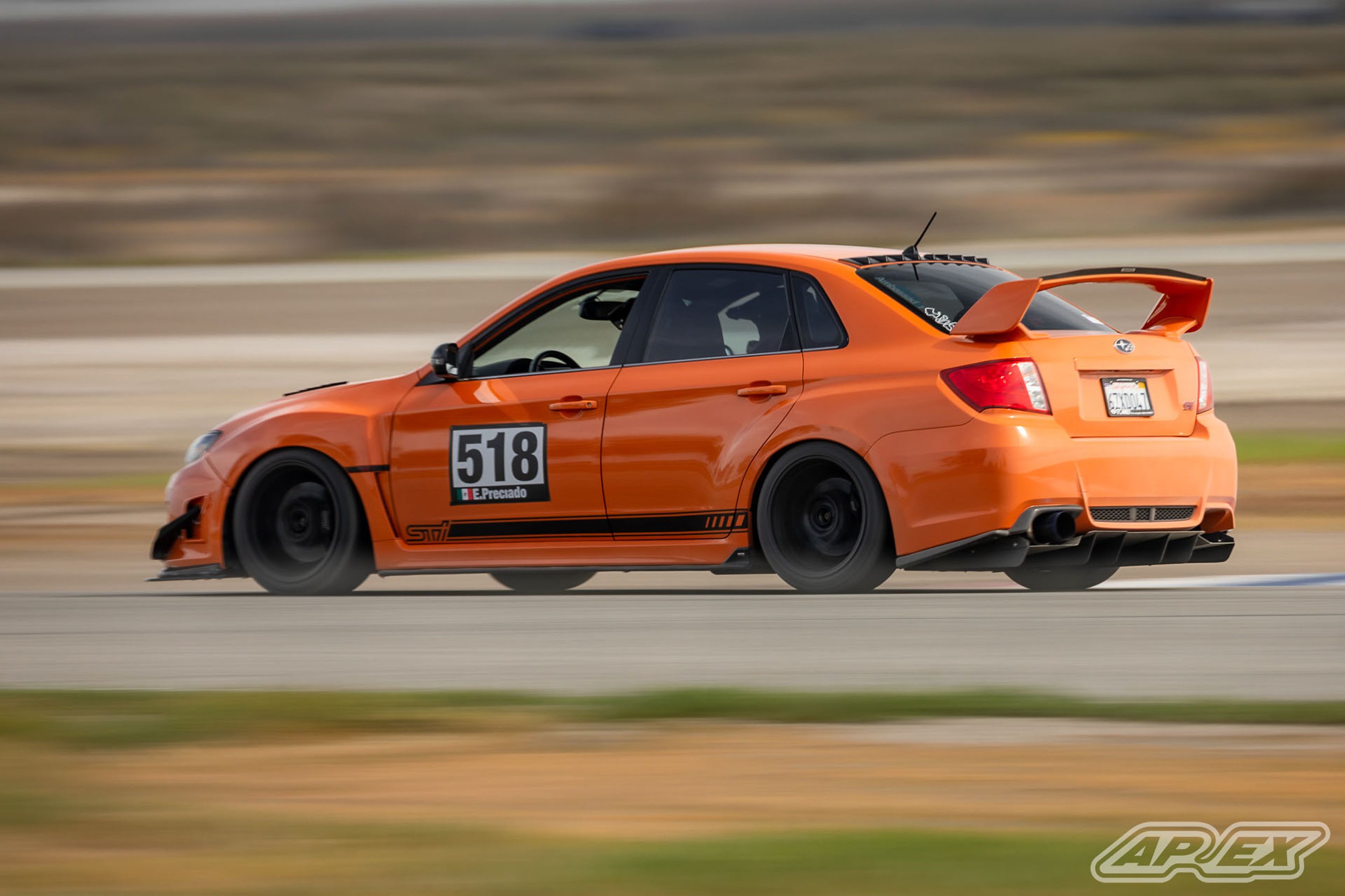 Orange Subaru GR WRX STI with 18" EC-7 Apex wheels in Satin Black