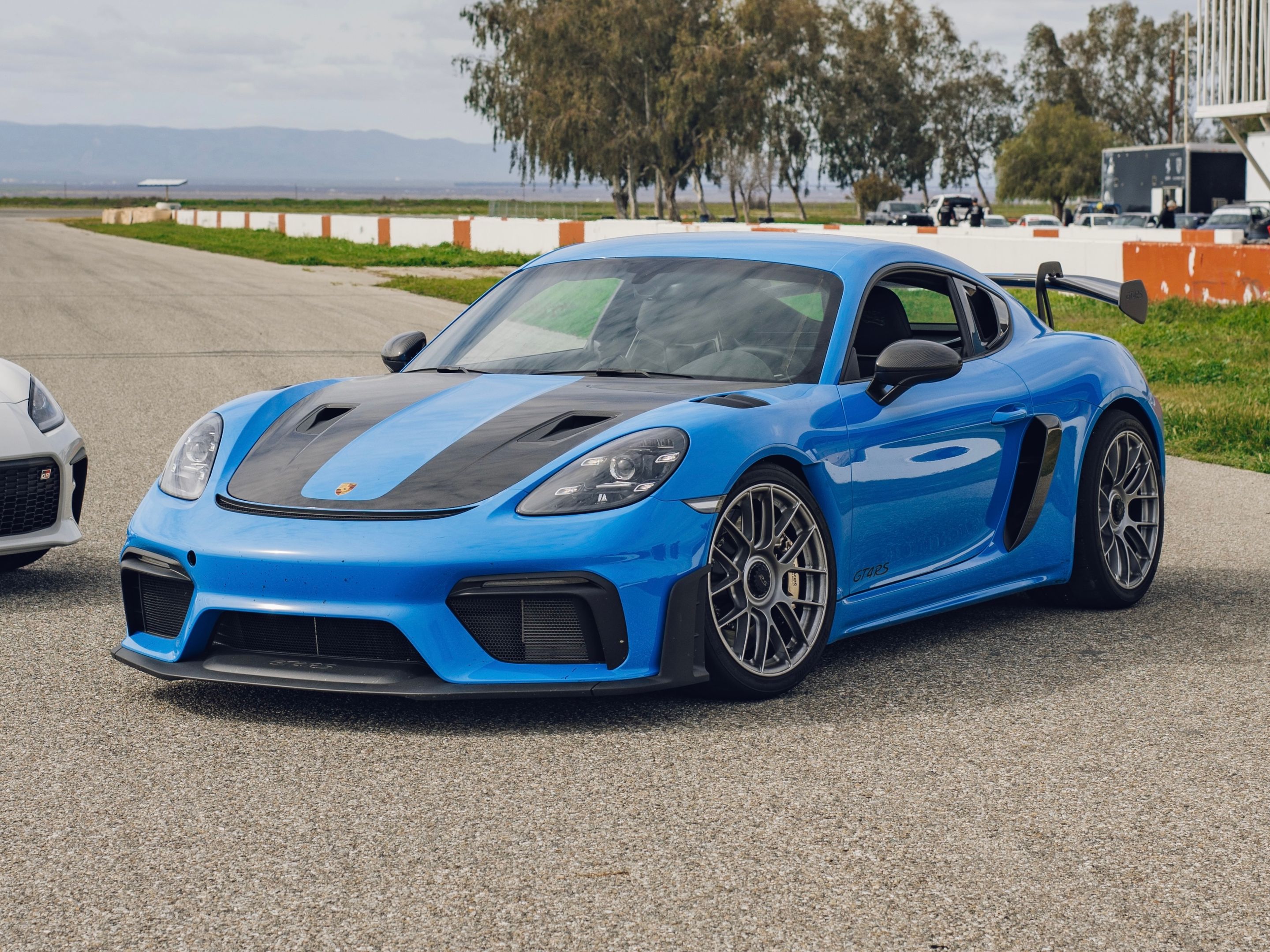 Blue Porsche 718 Cayman GT4 RS with 19" EC-7RS Apex wheels in Race Silver