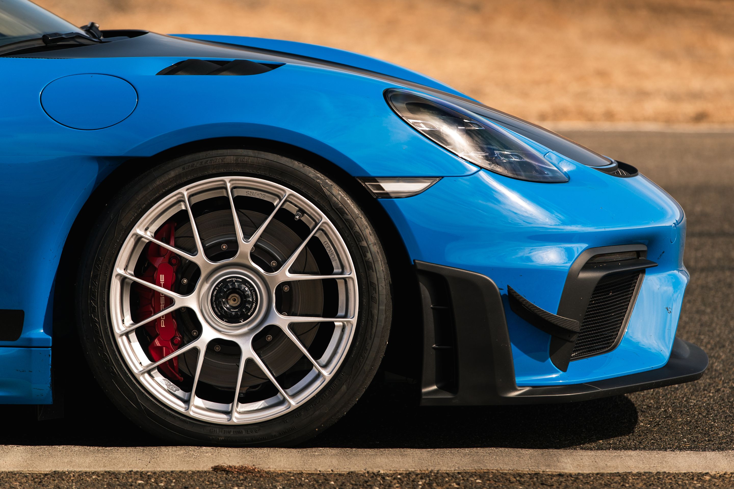 Blue Porsche 718 Cayman GT4 RS with 19" EC-7RS Apex wheels in Race Silver