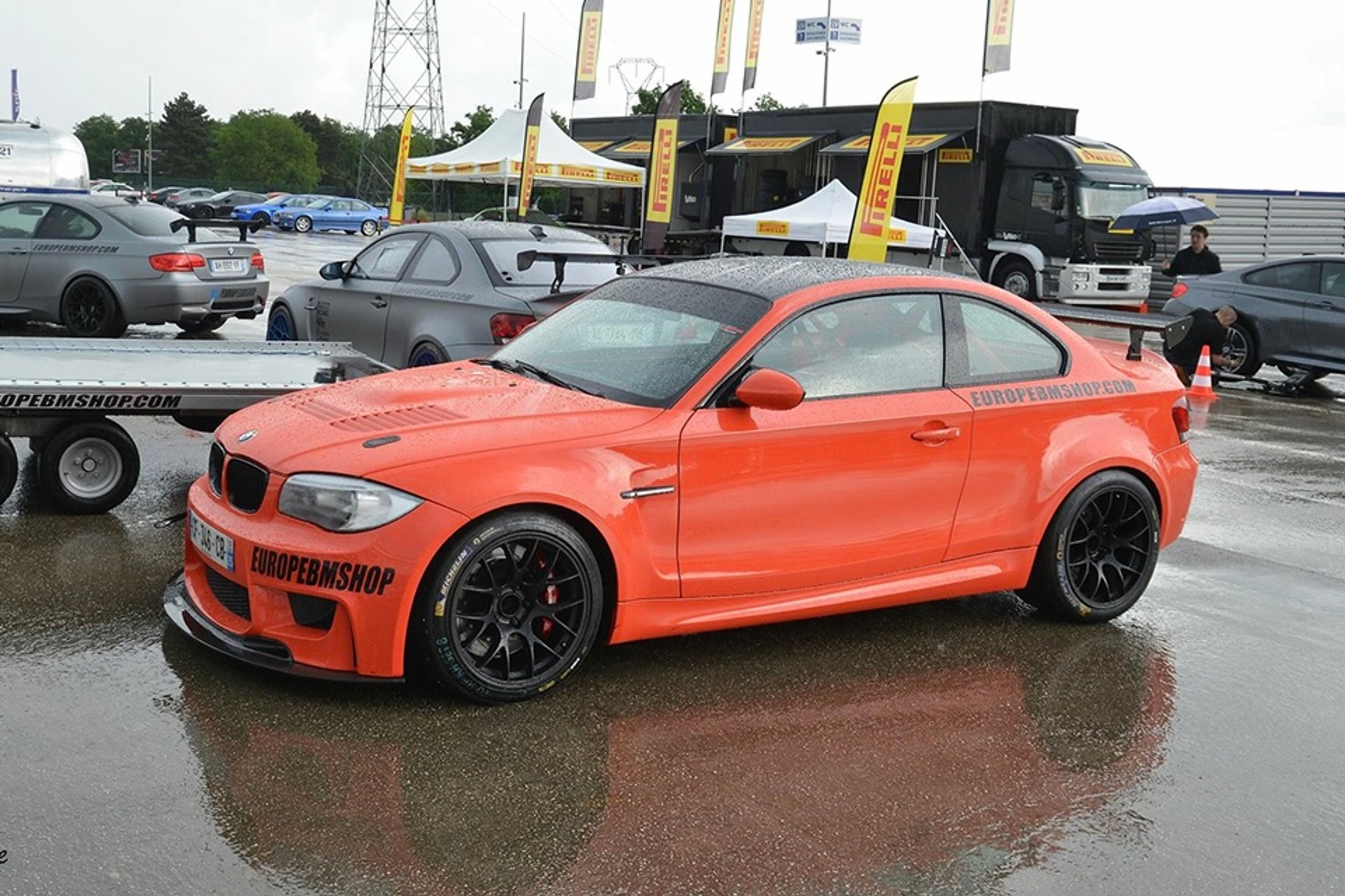 Orange BMW E82 1M with 18" EC-7 Apex wheels in Satin Black
