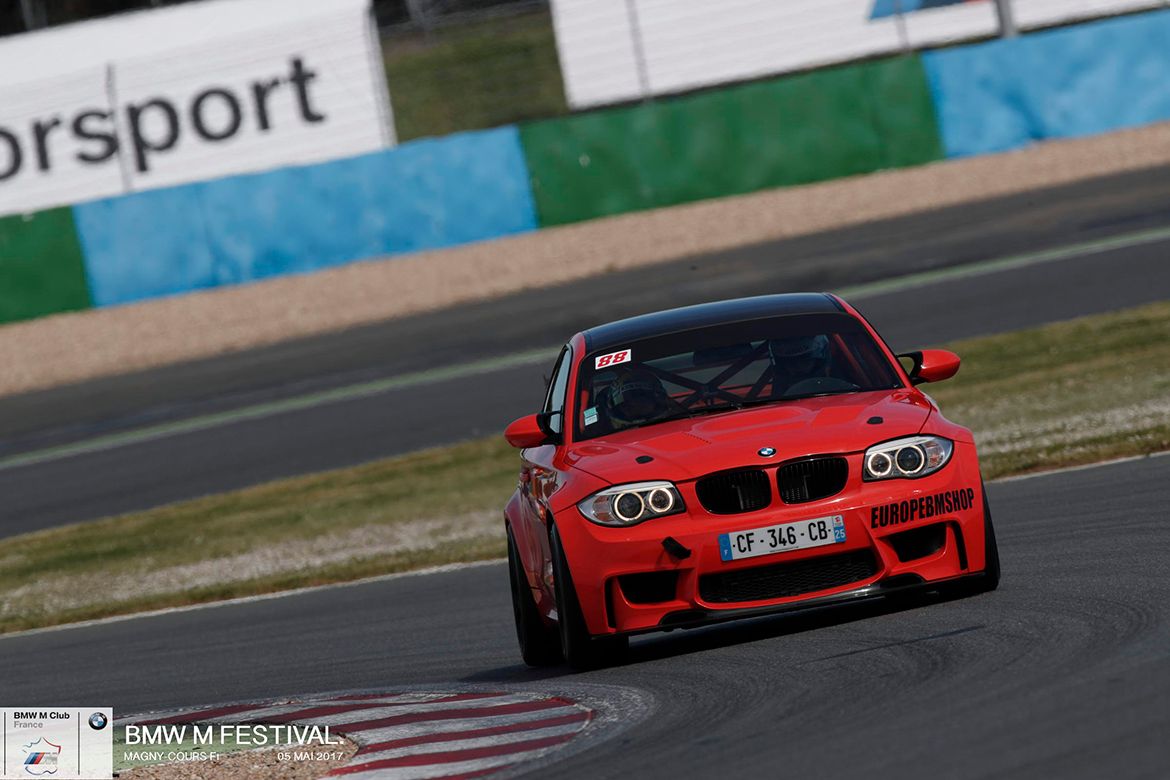 Orange BMW E82 1M with 18" EC-7 Apex wheels in Satin Black