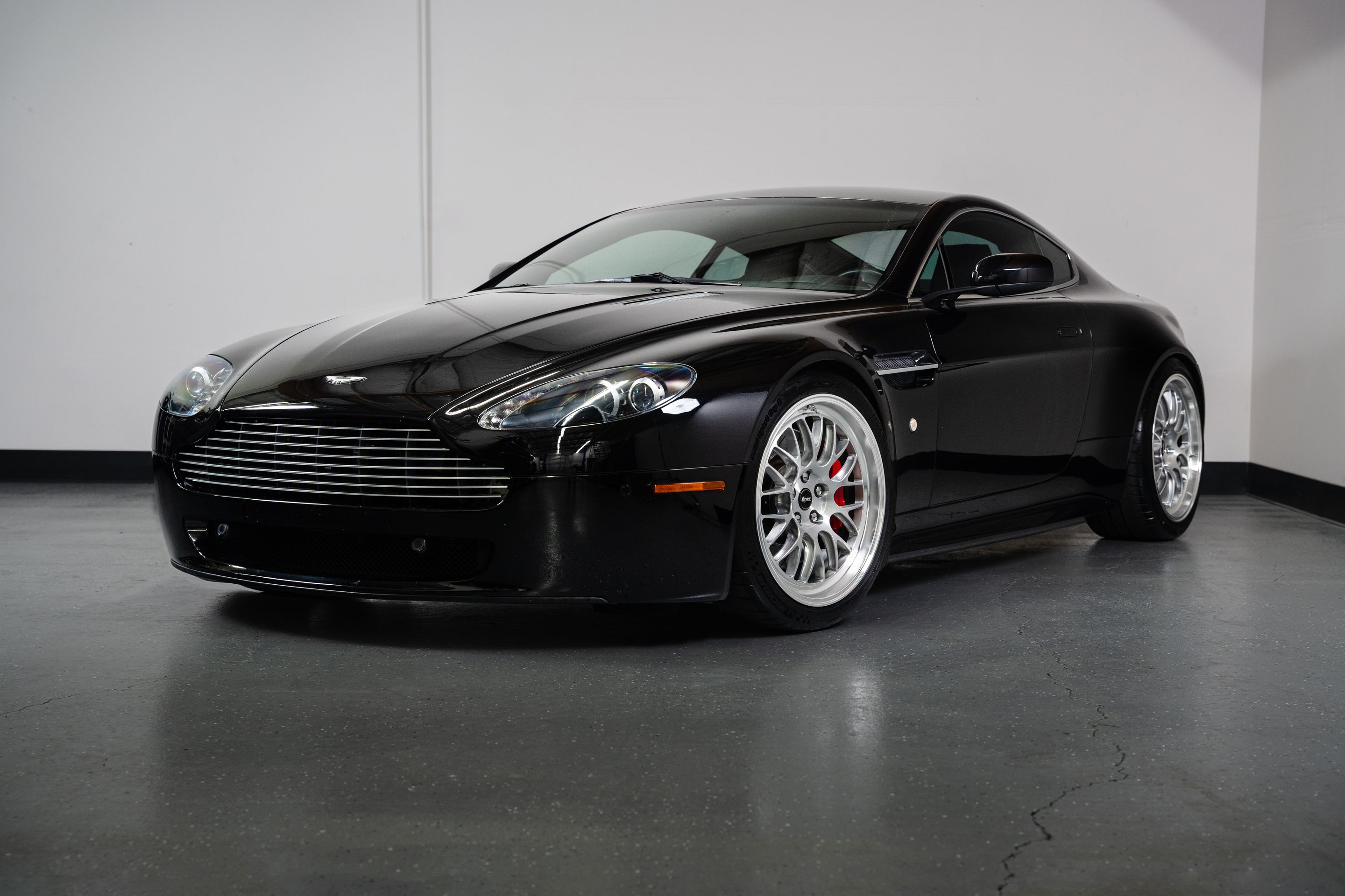 Black Aston Martin V8/V12 Vantage with 19" ML-10RT Apex wheels in Machined Lip Brushed Clear