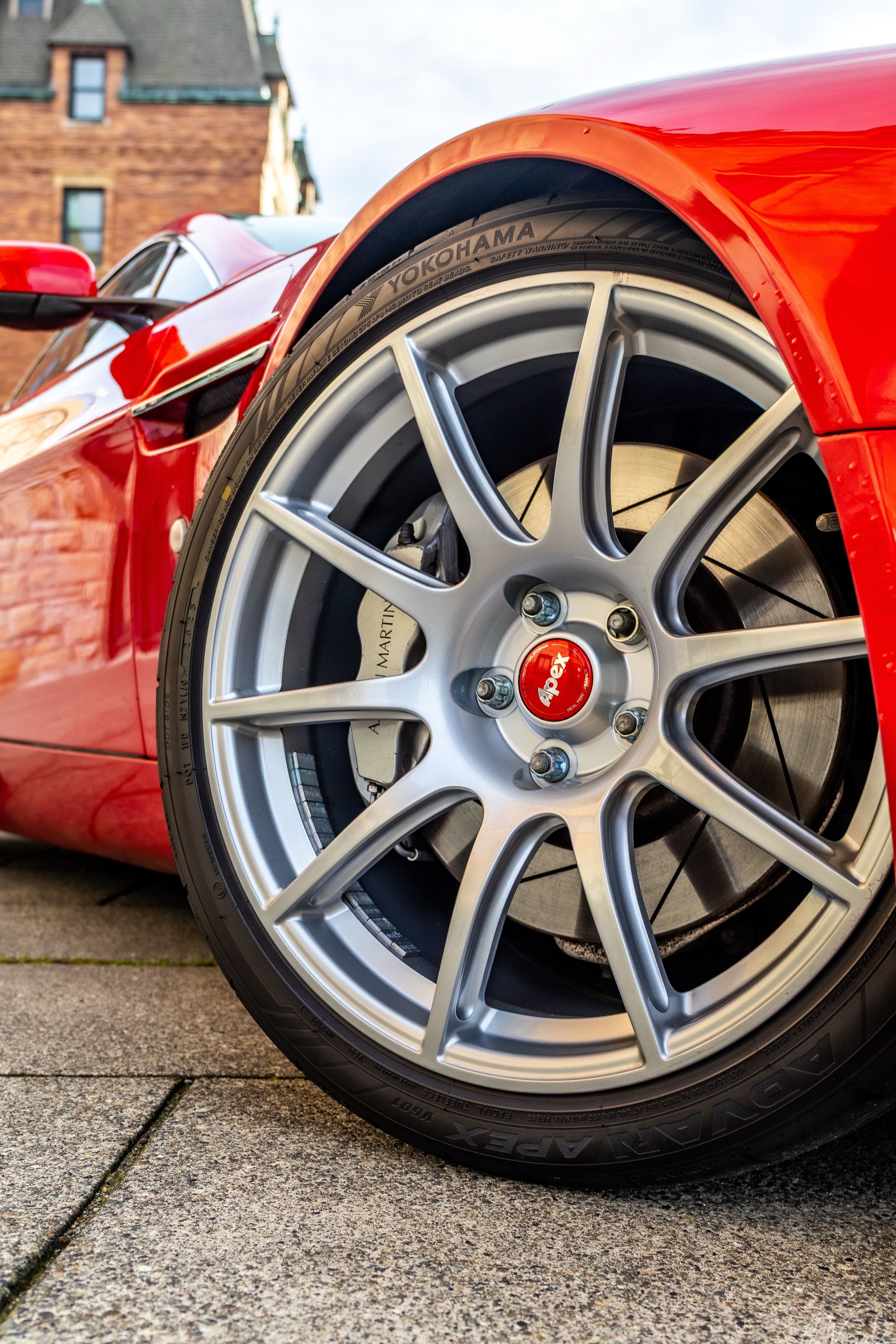 Red Aston Martin V8/V12 Vantage with 19" SM-10 Apex wheels in Race Silver