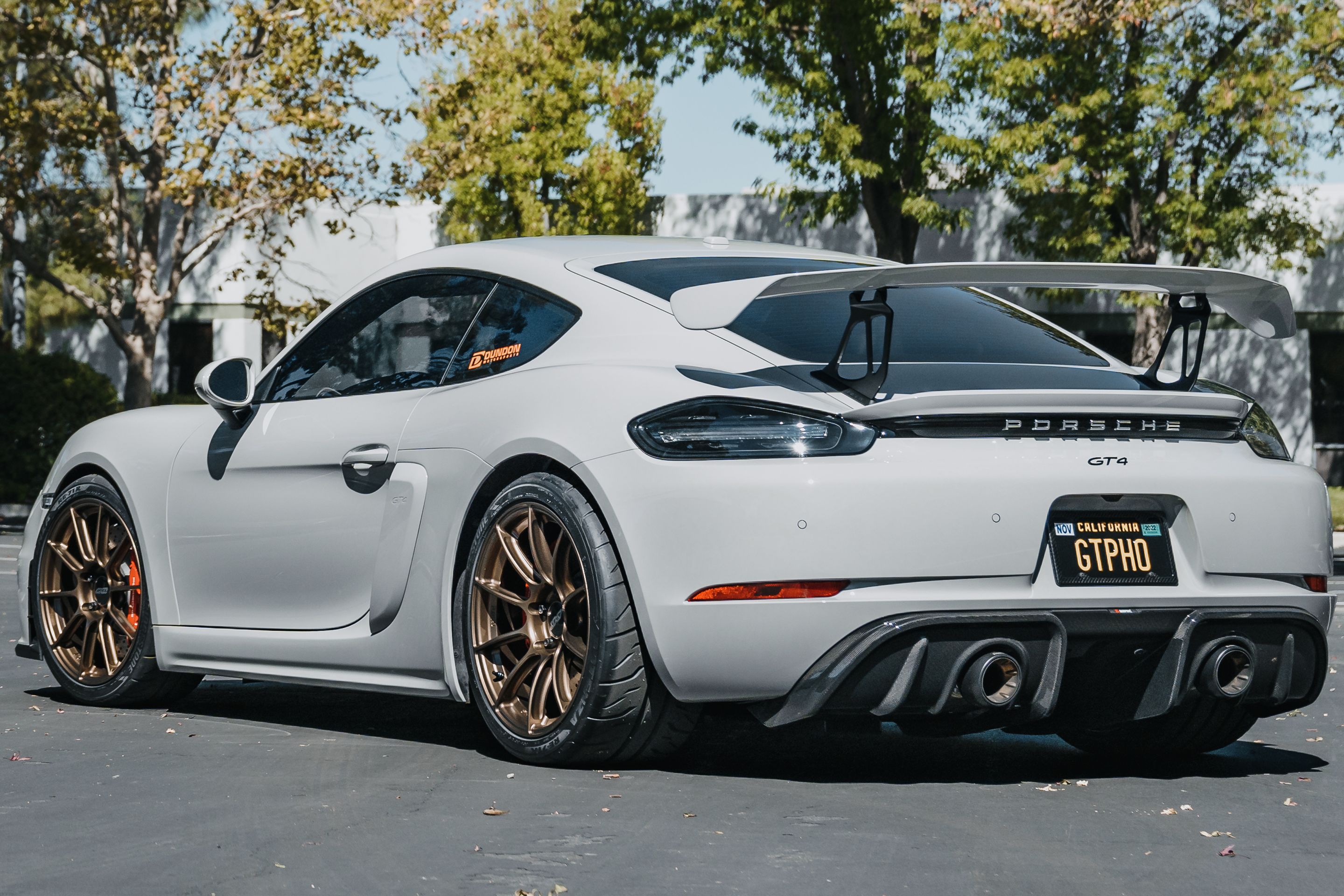 Grey Porsche 718 Cayman GT4 with 19" SM-10RS Apex wheels in Satin Bronze