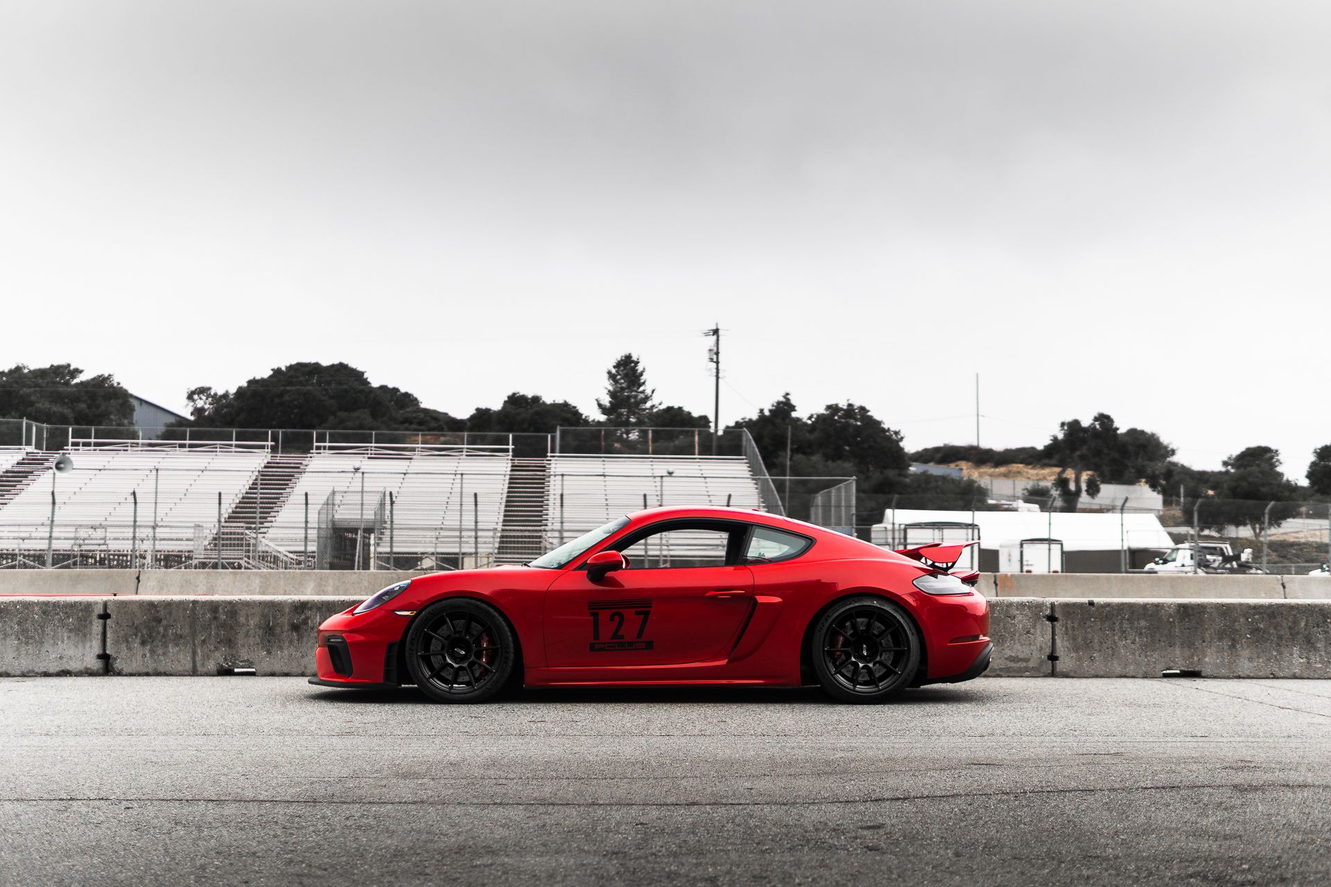 Red Porsche 718 Cayman GT4 with 19" SM-10 Apex wheels in Satin Black