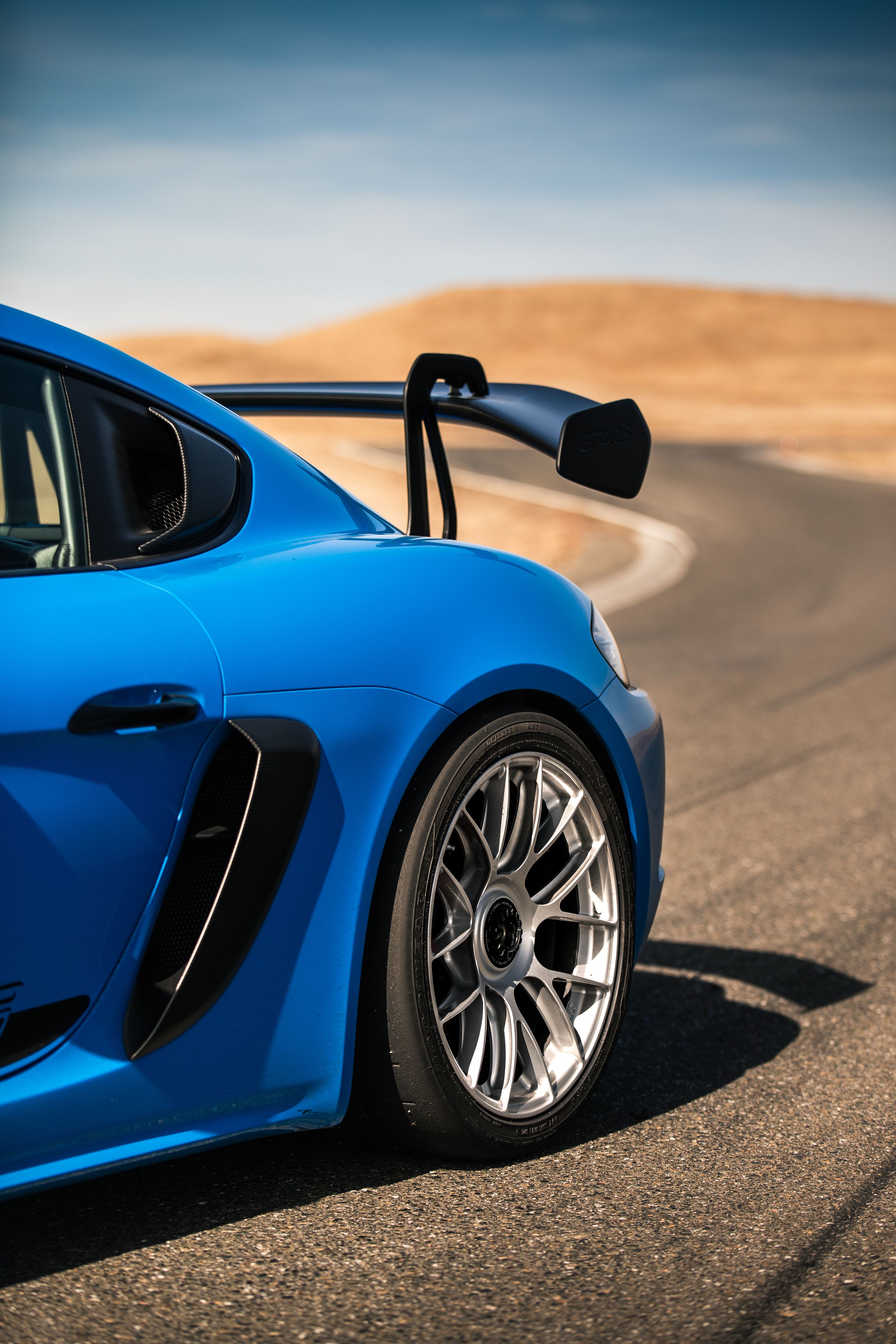 Blue Porsche 718 Cayman GT4 RS with 19" EC-7RS Apex wheels in Race Silver