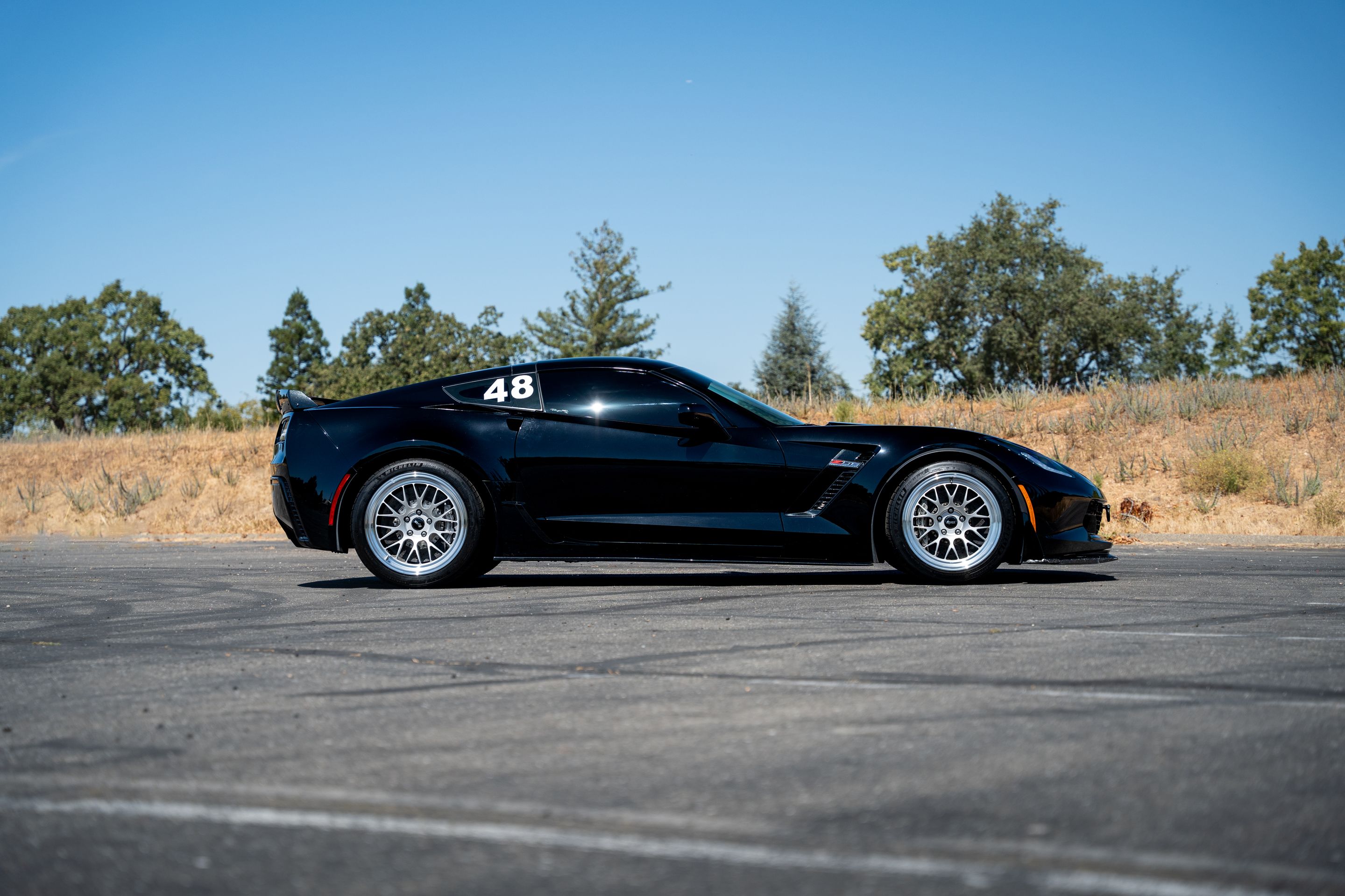 Black Chevrolet C7 Corvette Z06 with 18"/19" ML-10RT Apex wheels in Machined Lip Race Silver