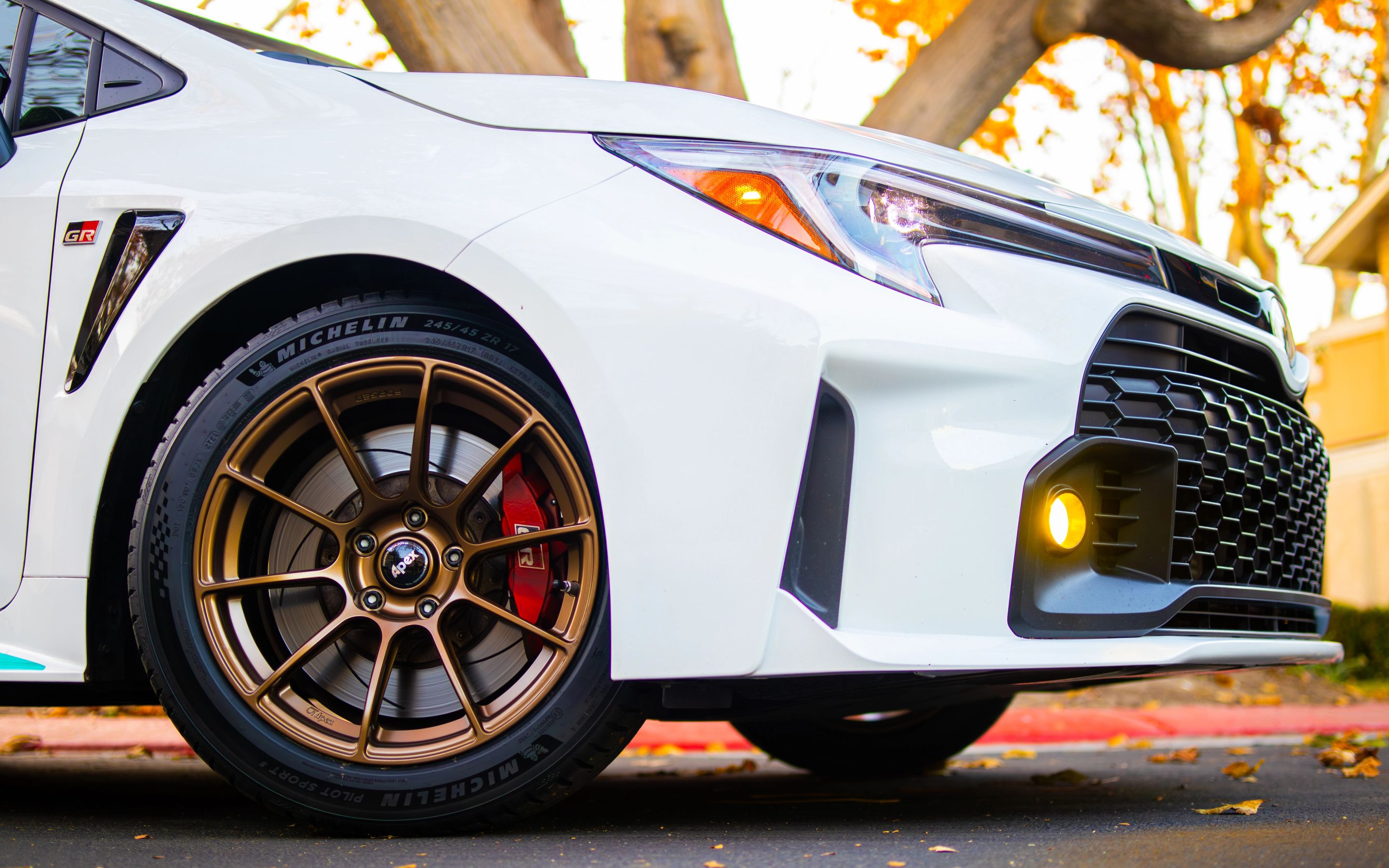 White Toyota GR Corolla with 17" SM-10RS Apex wheels in Satin Bronze