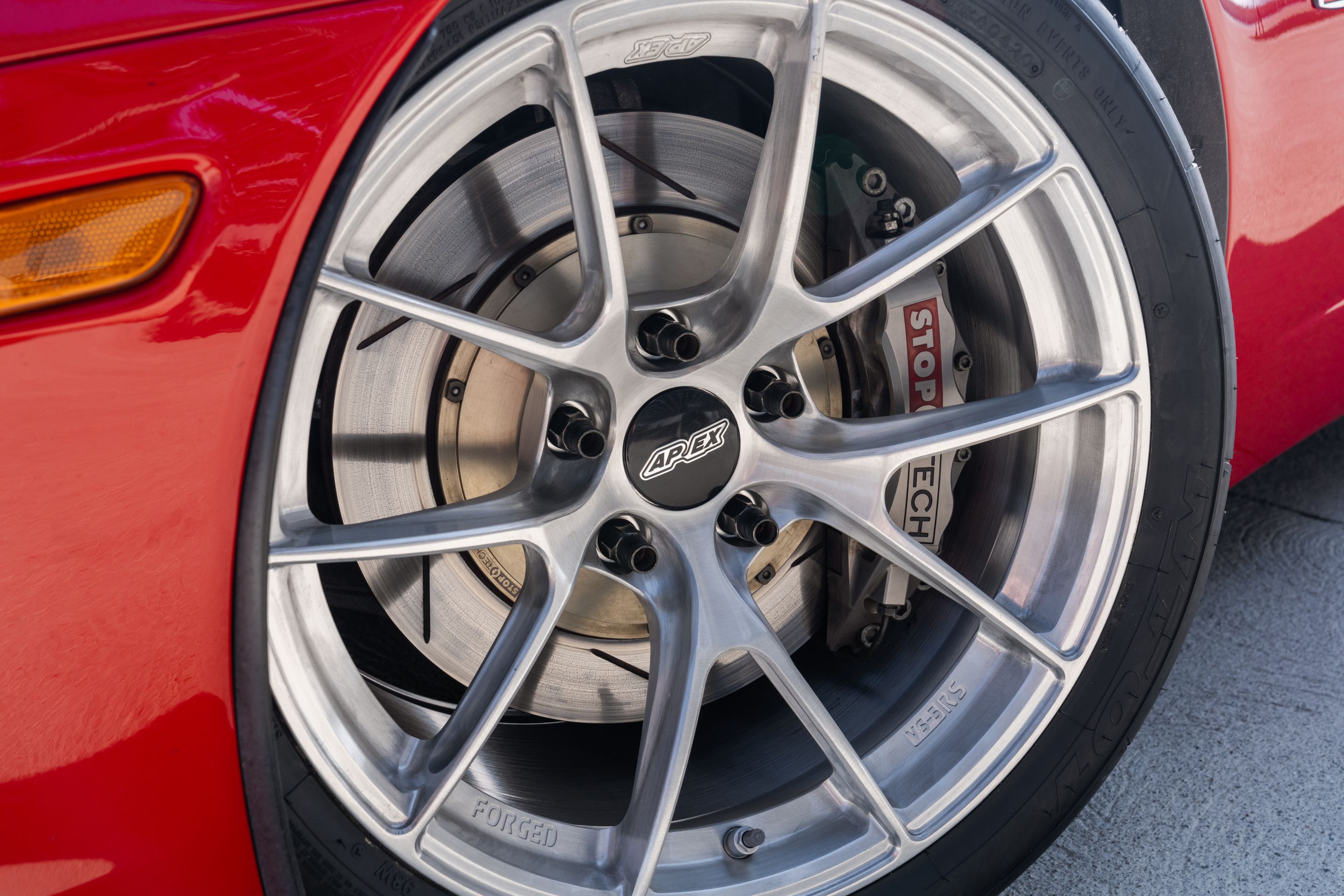 Red Chevrolet C6 Corvette Z06 with 18" VS-5RS Apex wheels in Brushed Clear