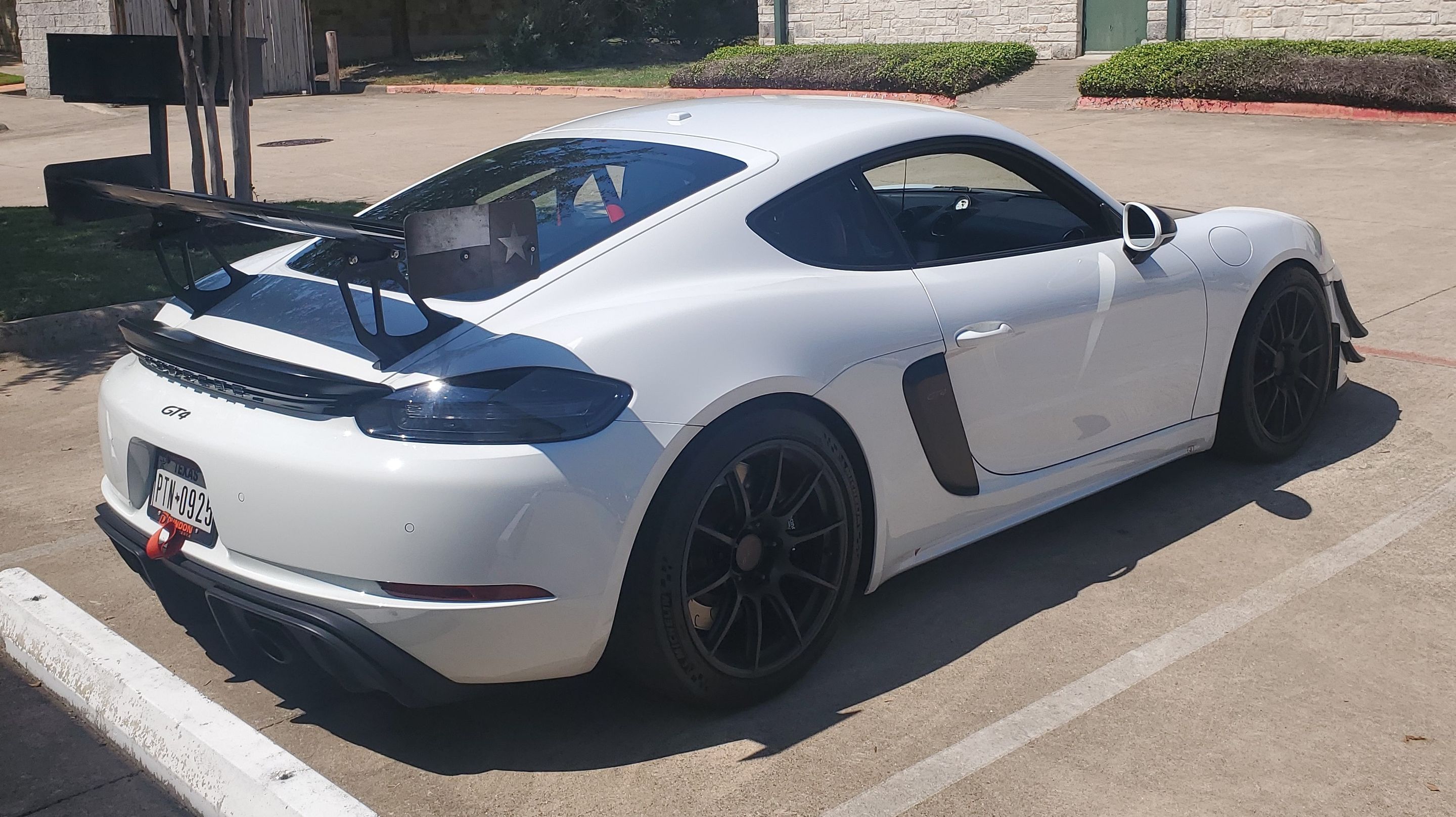 White Porsche 718 Cayman GT4 with 19" SM-10 Apex wheels in Satin Black
