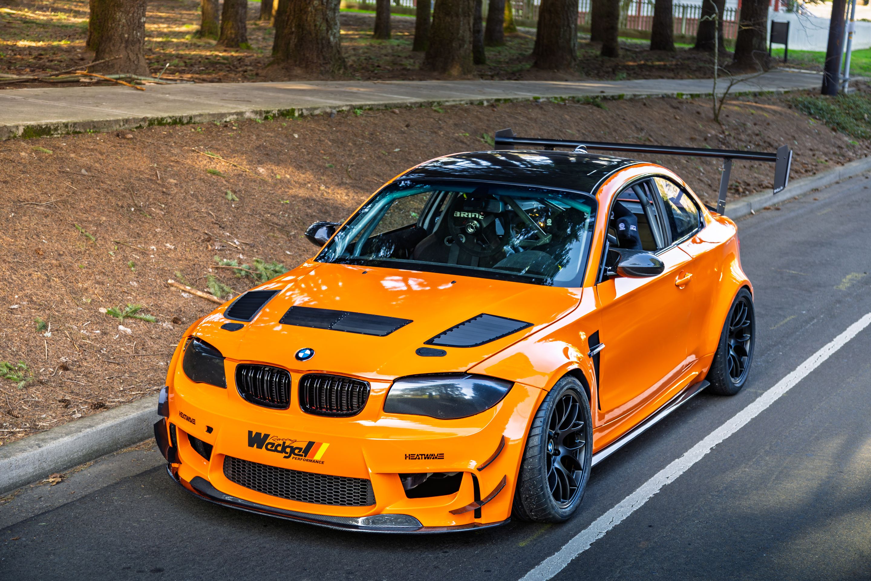 Orange BMW E82 1M with 18" EC-7 Apex wheels in Satin Black