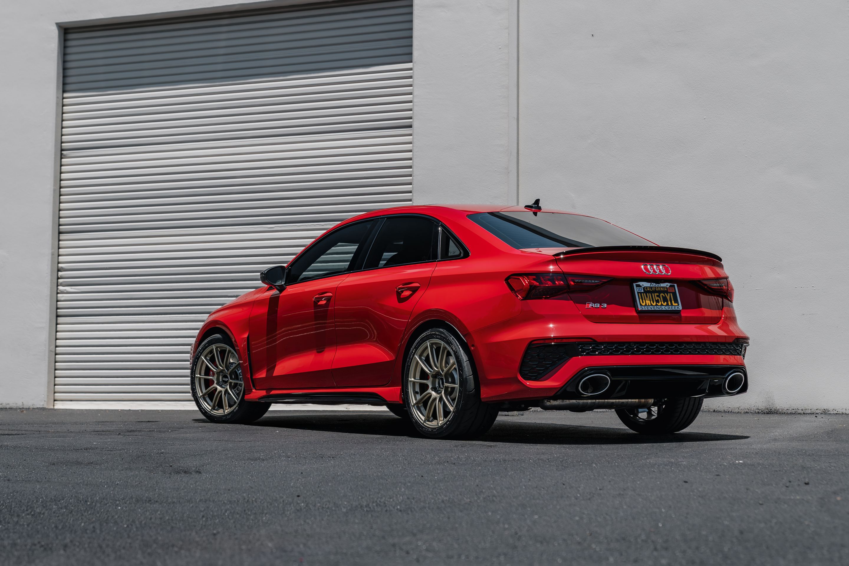 Red Audi 8Y RS 3 with 18" SM-10RS Apex wheels in Motorsport Gold