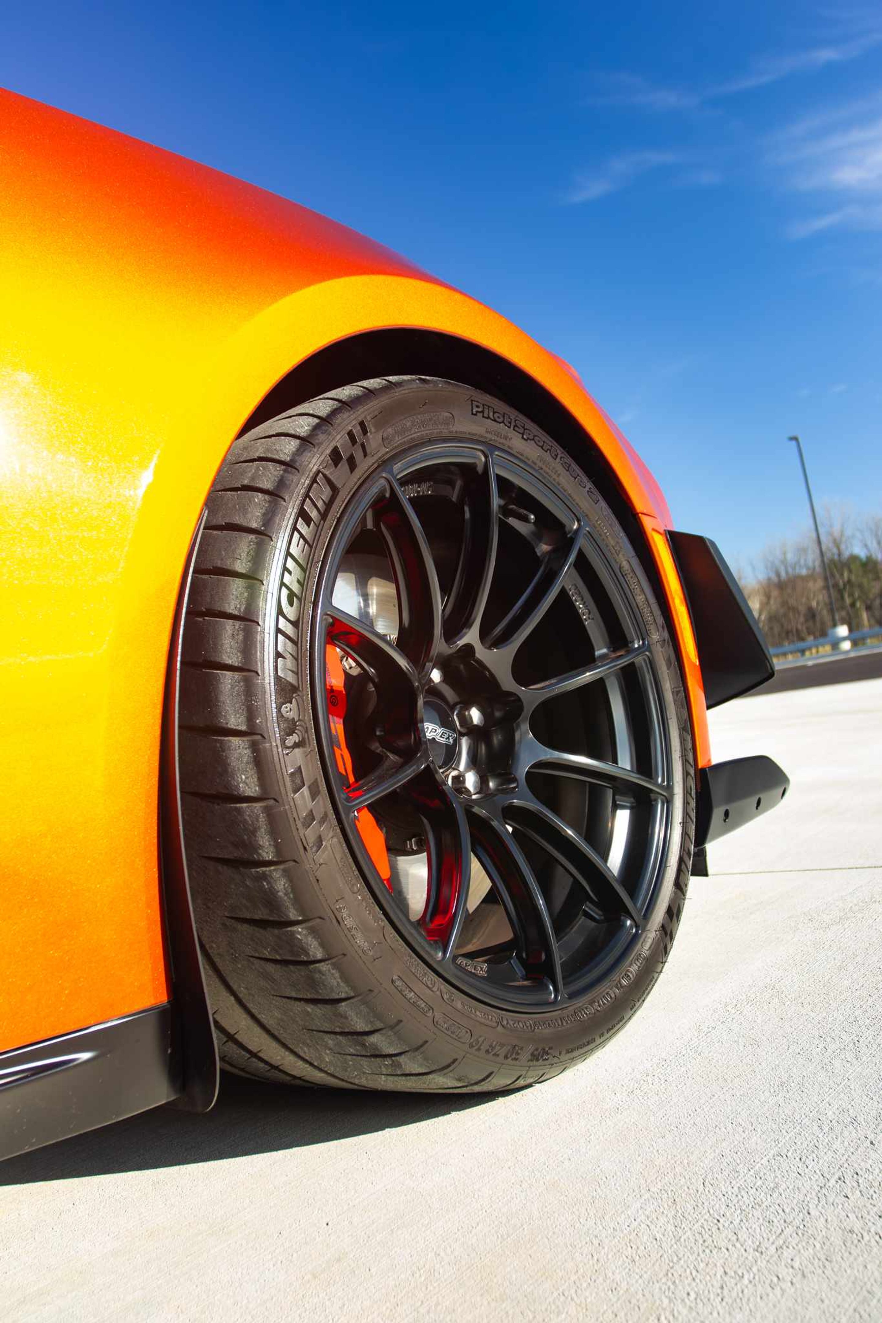Red Chevrolet 6th Gen Camaro ZL1 1LE with 19" SM-10RS Apex wheels in Satin Black