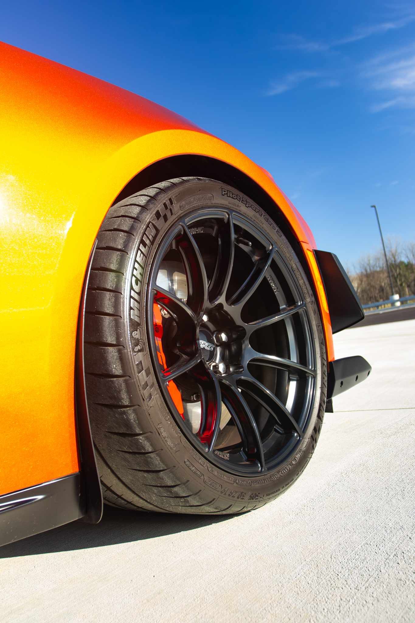 Red Chevrolet 6th Gen Camaro ZL1 1LE with 19" SM-10RS Apex wheels in Satin Black