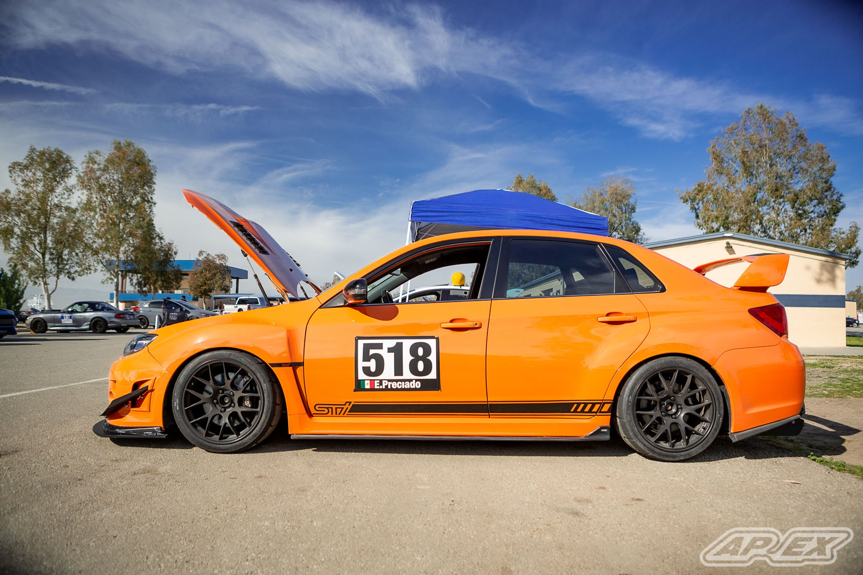 Orange Subaru GR WRX STI with 18" EC-7 Apex wheels in Satin Black