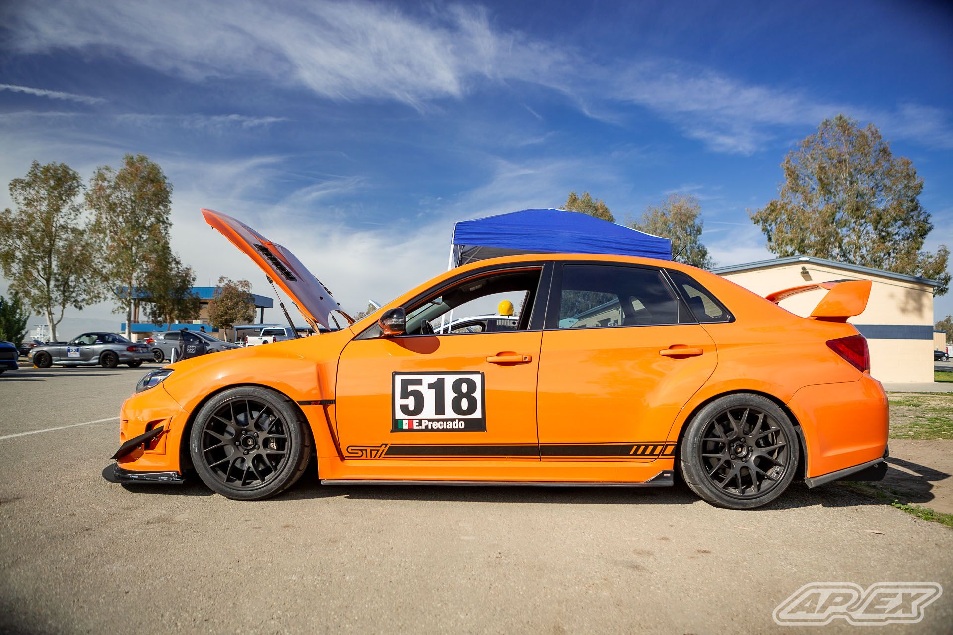 Orange Subaru GR WRX STI with 18" EC-7 Apex wheels in Satin Black
