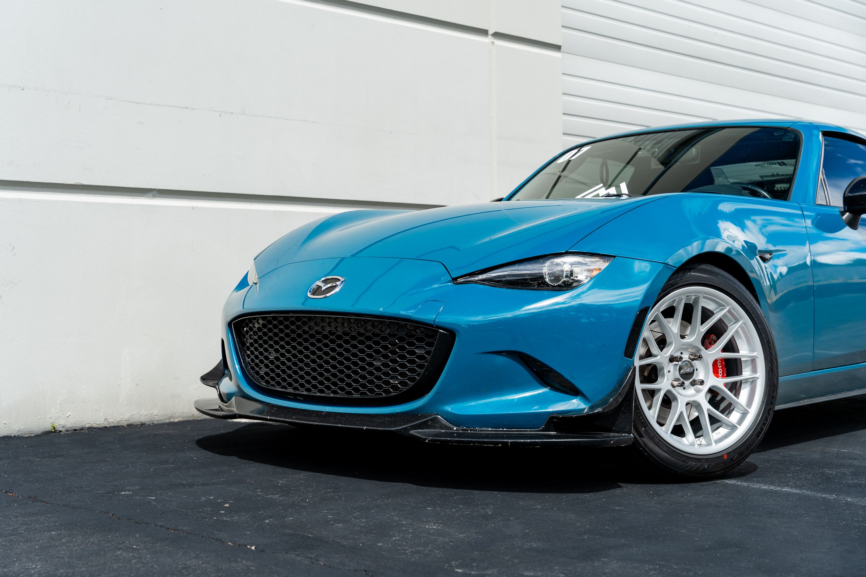 Blue Mazda ND MX-5 Miata with 17" ARC-8 Apex wheels in Race Silver